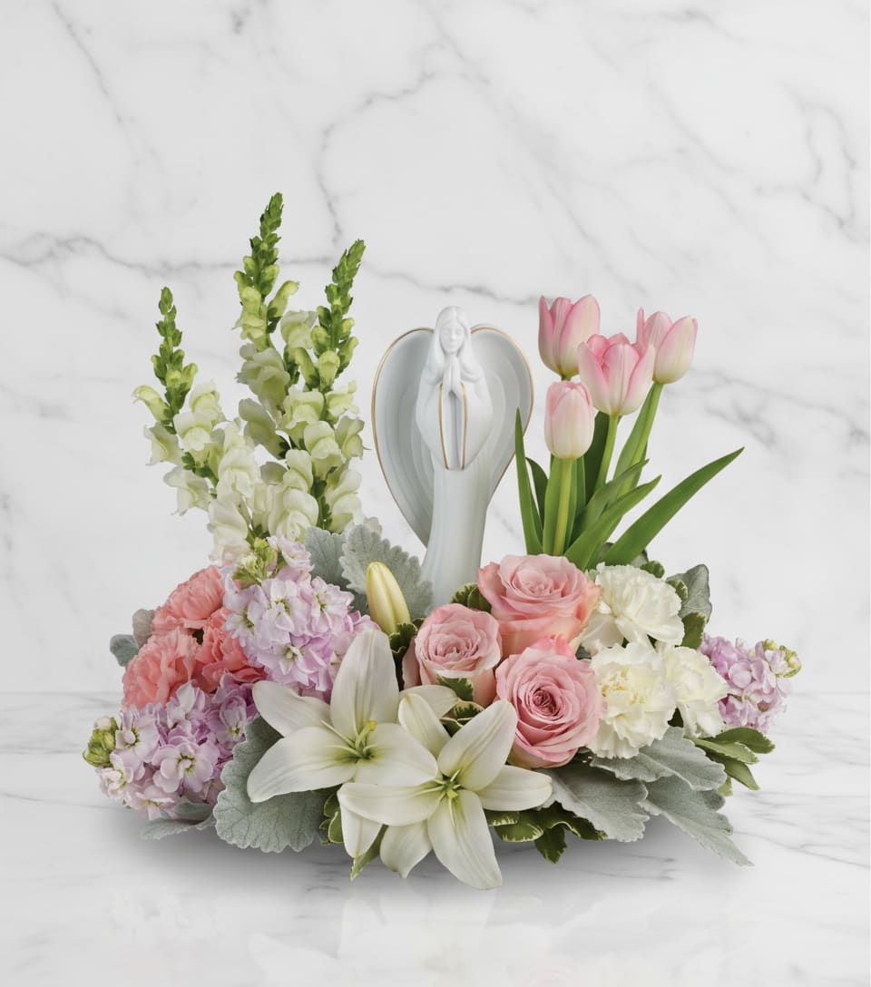 Garden Of Hope Bouquet - Show them you care with this gorgeous display of roses, lilies and tulips, gracefully surrounding a timeless angel sculpture keepsake. Beautifully fragrant, it's a hopeful tribute that will warm their hearts forever.  The scale of the arrangement should determine the type of substitution acceptable, but the substitution must be of equal or greater value and must maintain the style and color harmony of the original order.