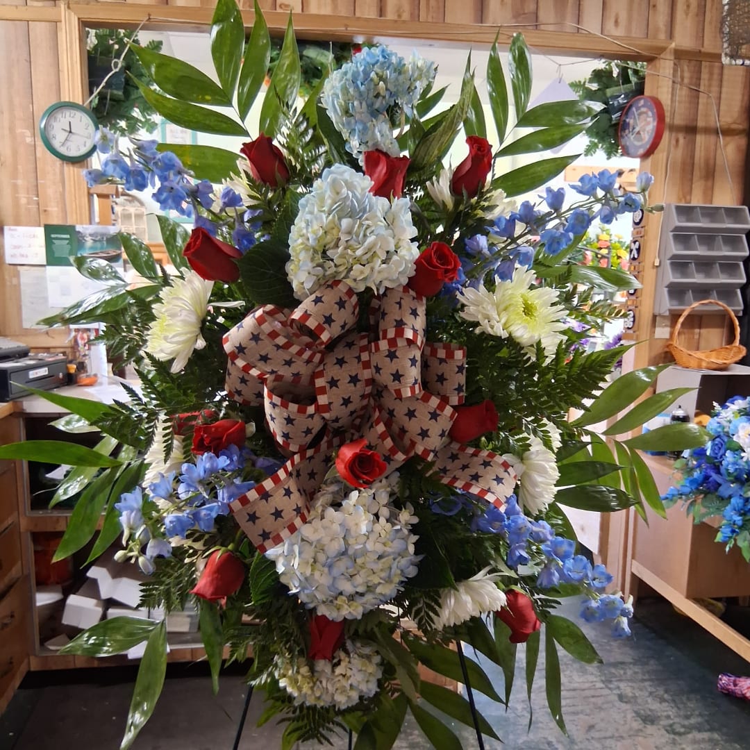 Large patriotic standing floral spray with red, white, and blue flowers