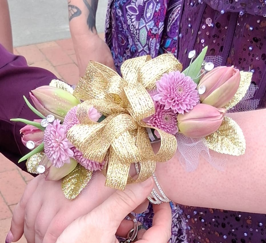 Pink tulip corsage with purple daisies and a gold ribbon bow