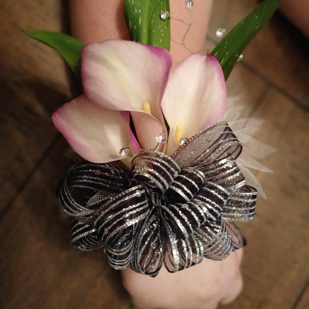 Pink-and-white calla lily corsage with a black-and-silver ribbon bow