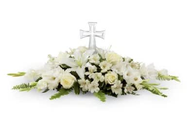 White floral casket spray with a clear cross centerpiece