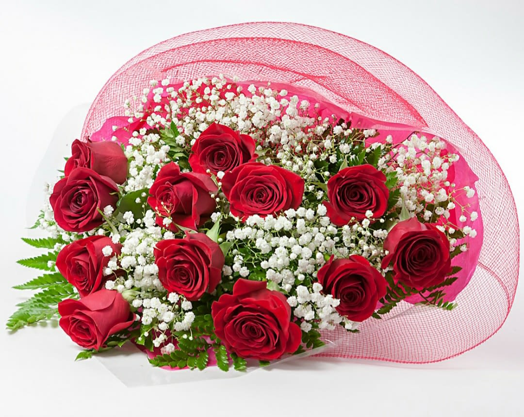 Bouquet of red roses with white baby's breath wrapped in pink mesh