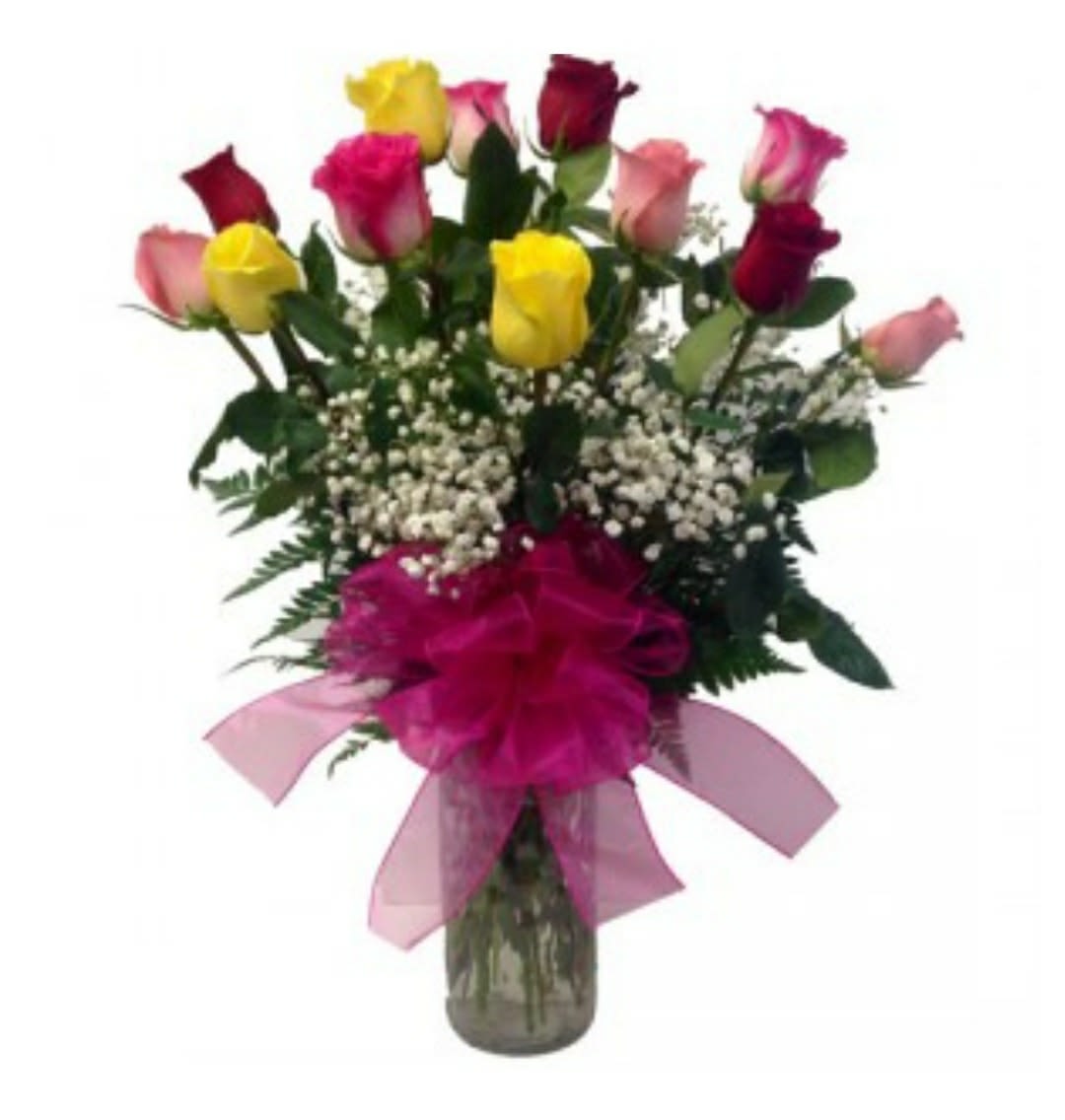 Bouquet of multicolored roses in a glass vase with a pink bow