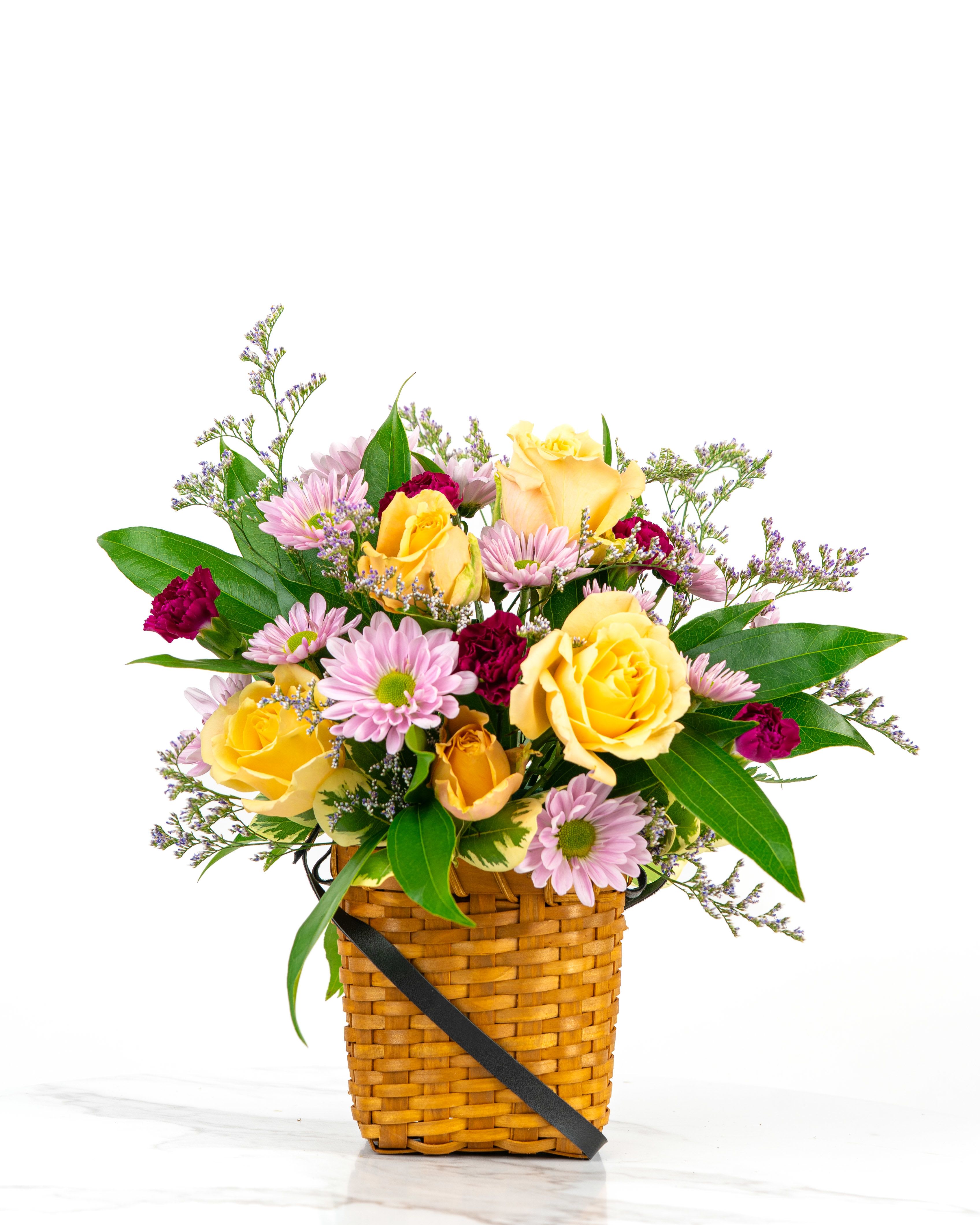Our Birthday Collection: Surprise Mini Basket - Let our floral design team send birthday wishes with a color and style chosen based on our best blooms using an adorable mini basket with black strap.   At Schultz Floral, each arrangement is one of a kind and styled just for your order. Because we always use the freshest blooms, your final arrangement may not look exactly as pictured due to seasonal availability. Rather, a Birthday Surprise Mini Basket is intended to celebrate creativity and artful color combinations in a mini basket vessel. Happy Birthday!  This is a top seller in Valparaiso, Chesterton, and Boone Grove (Indiana).