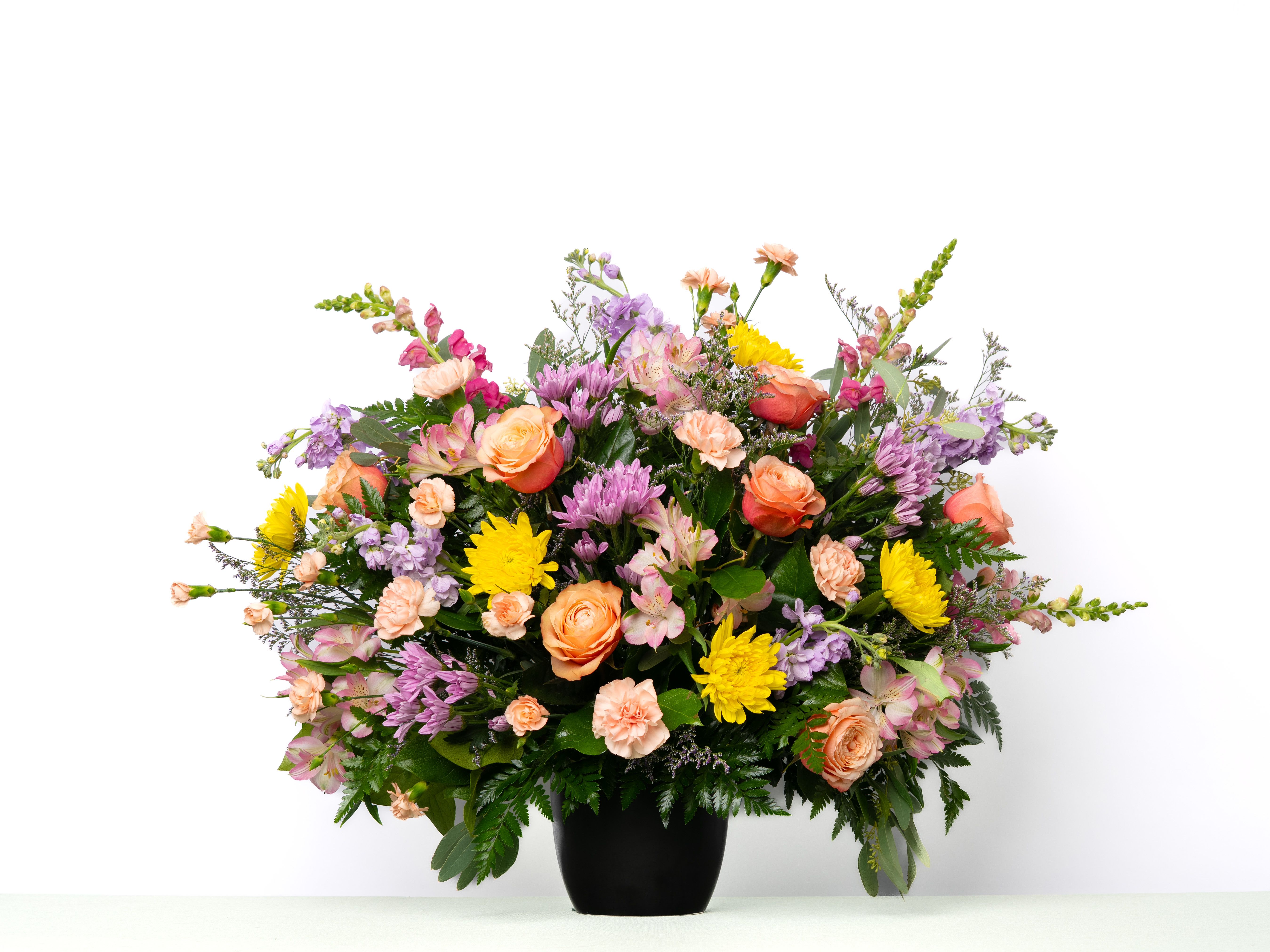 Our Hope Collection: Tribute Urn in Pastel Blooms - Soft pastel blooms create a gentle and comforting tribute, offering a sense of peace and reflection. Designed to complement the urn with natural beauty and grace.  Each arrangement is thoughtfully designed using the freshest blooms available. Flower varieties may vary based on availability while maintaining the overall style, color palette, and value. Urn styles and colors may change based on weekly availability and will be substituted to maintain the overall value.  Approximate Dimensions of Floral Tribute: 24" tall x 36" wide  Color &amp; Customization: Need a custom color scheme? Contact us for more information. Our most popular palettes include whites, whites and greens, whites and blues, pinks and whites, pastel shades, and colorful designs.  Delivery: All sympathy pieces are hand-delivered by the Schultz Floral team.