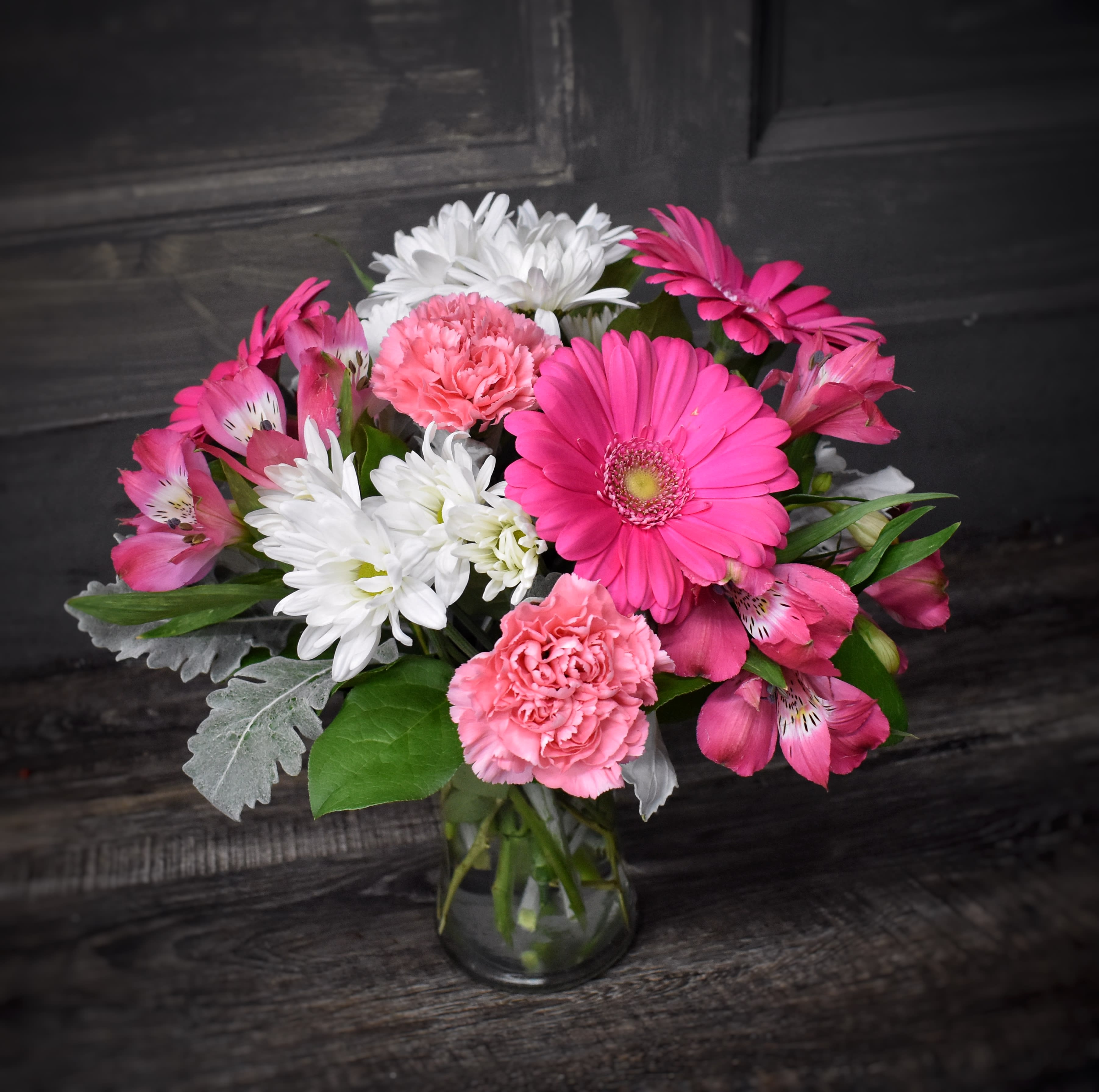 Pink and white mixed bouquet in a clear glass vase