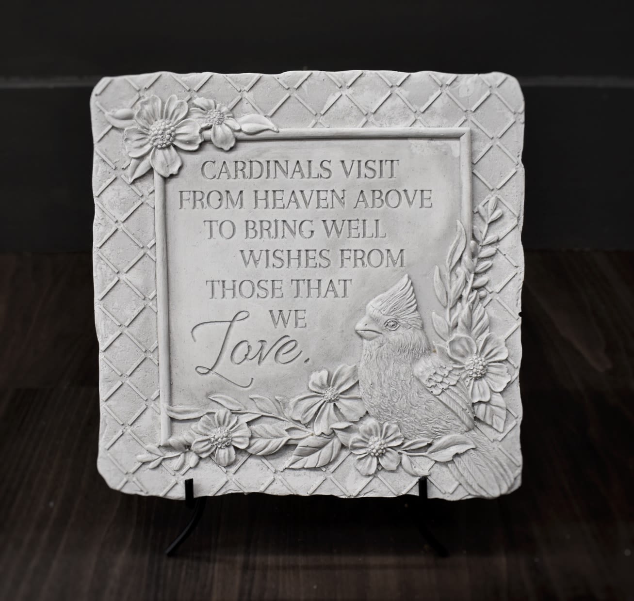 Decorative memorial plaque with a cardinal and floral relief