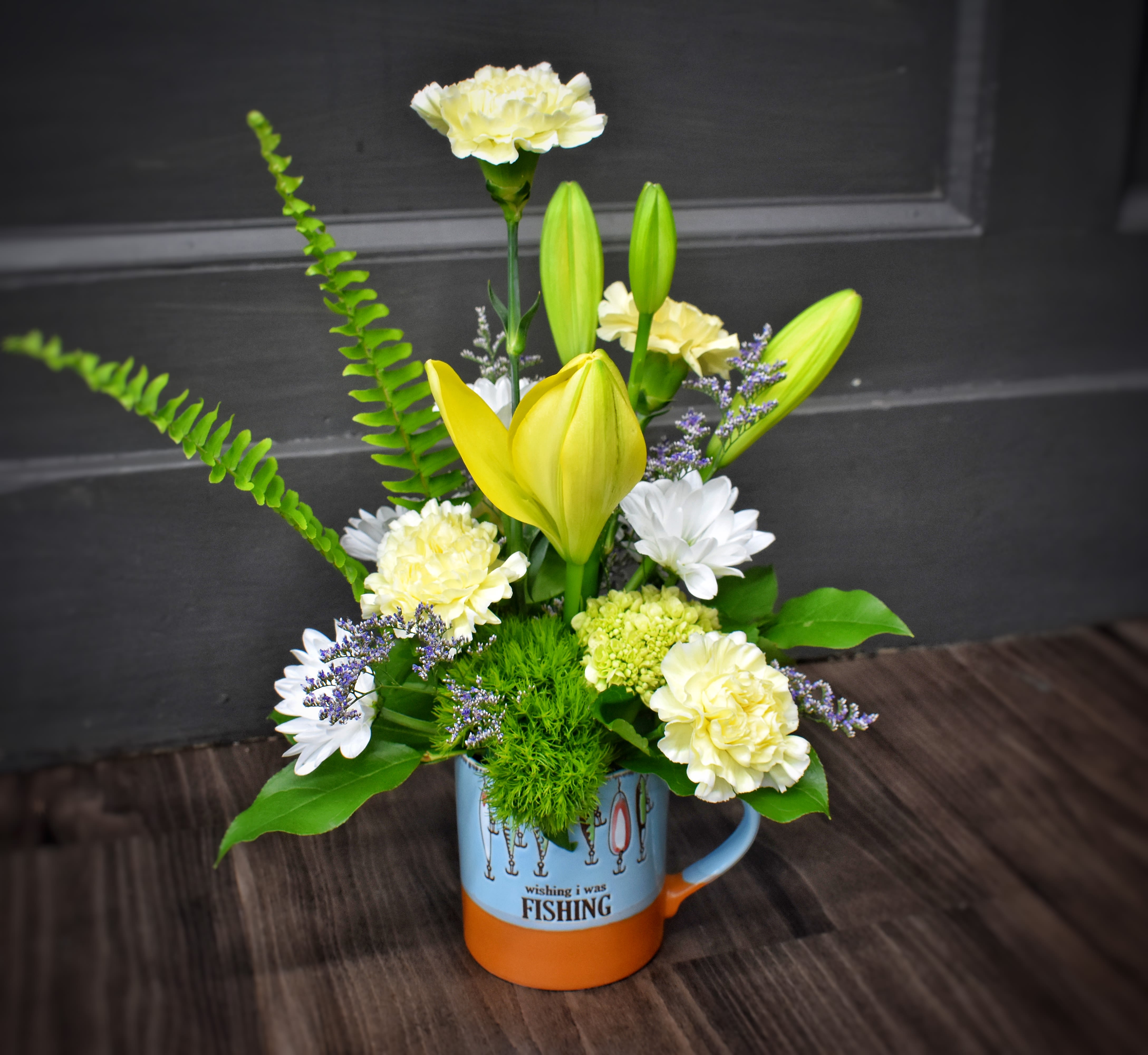 Wish I was Fishing! - Our large coffee mugs with embossed lures on the side is filled with flowers and makes a great gift for the fisher person in your life!