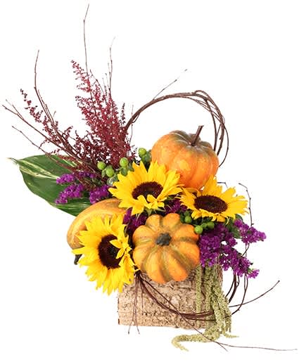 Autumn arrangement with sunflowers and pumpkins in a rustic container
