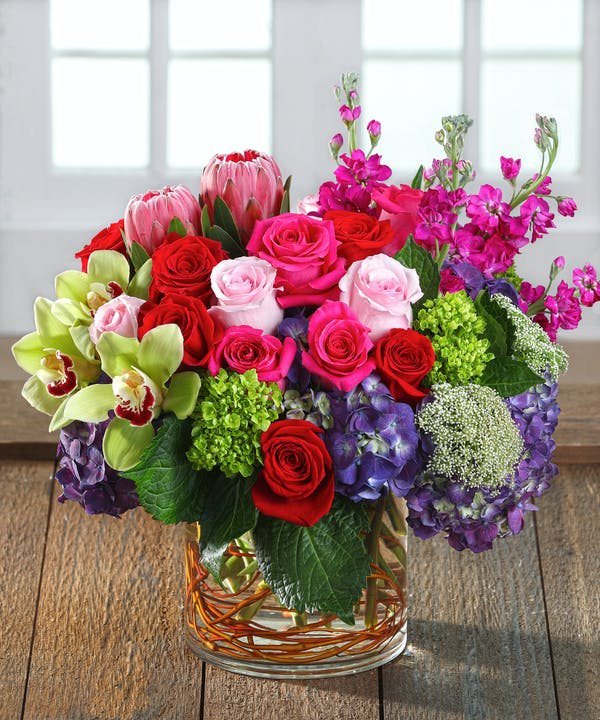 Bountiful and bright  - exotic and elegant floral arrangement premium flowers made up of hydrangeas, roses, stock, cymbidium orchids, roses, spray roses, stock, Lisianthus and others in a low vase.  Delivery minimum is $50.00 Our DELIVERY SERVICE IS TILL 3 PM We cannot guarantee requests for a specific time of delivery. There might be flower substitutions, due to low supply of certain flowers. However, we do our best to provide you with the same look and feel of the arrangement. Our main goal is to always give our customers quality flowers and service. To make sure that you get the exact same flowers, ordering a few days ahead of desired delivery date is key.