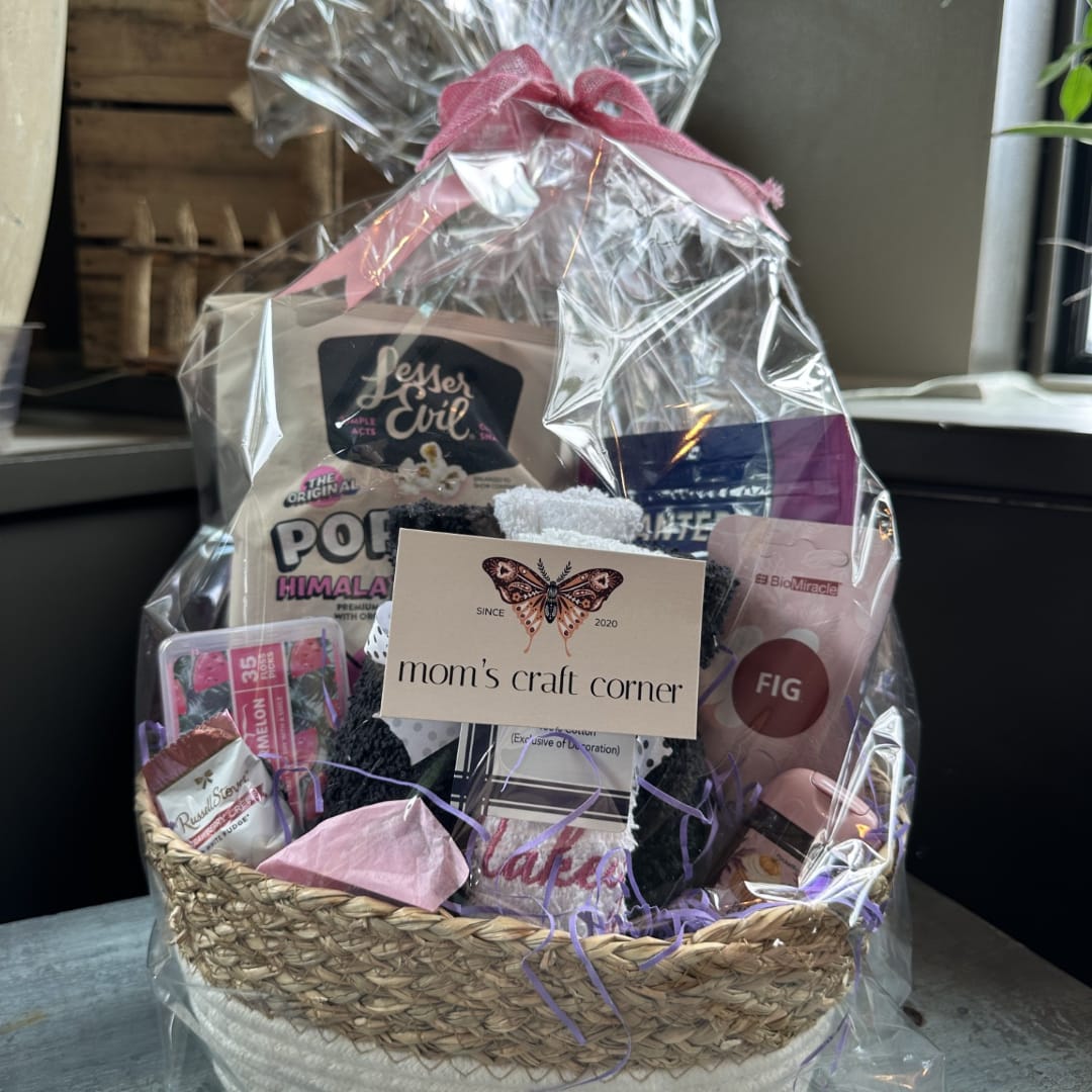 Gift basket with assorted packaged treats and bath items in clear wrap