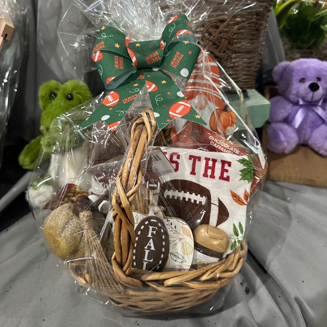 Basket gift set with football decor and a green bow