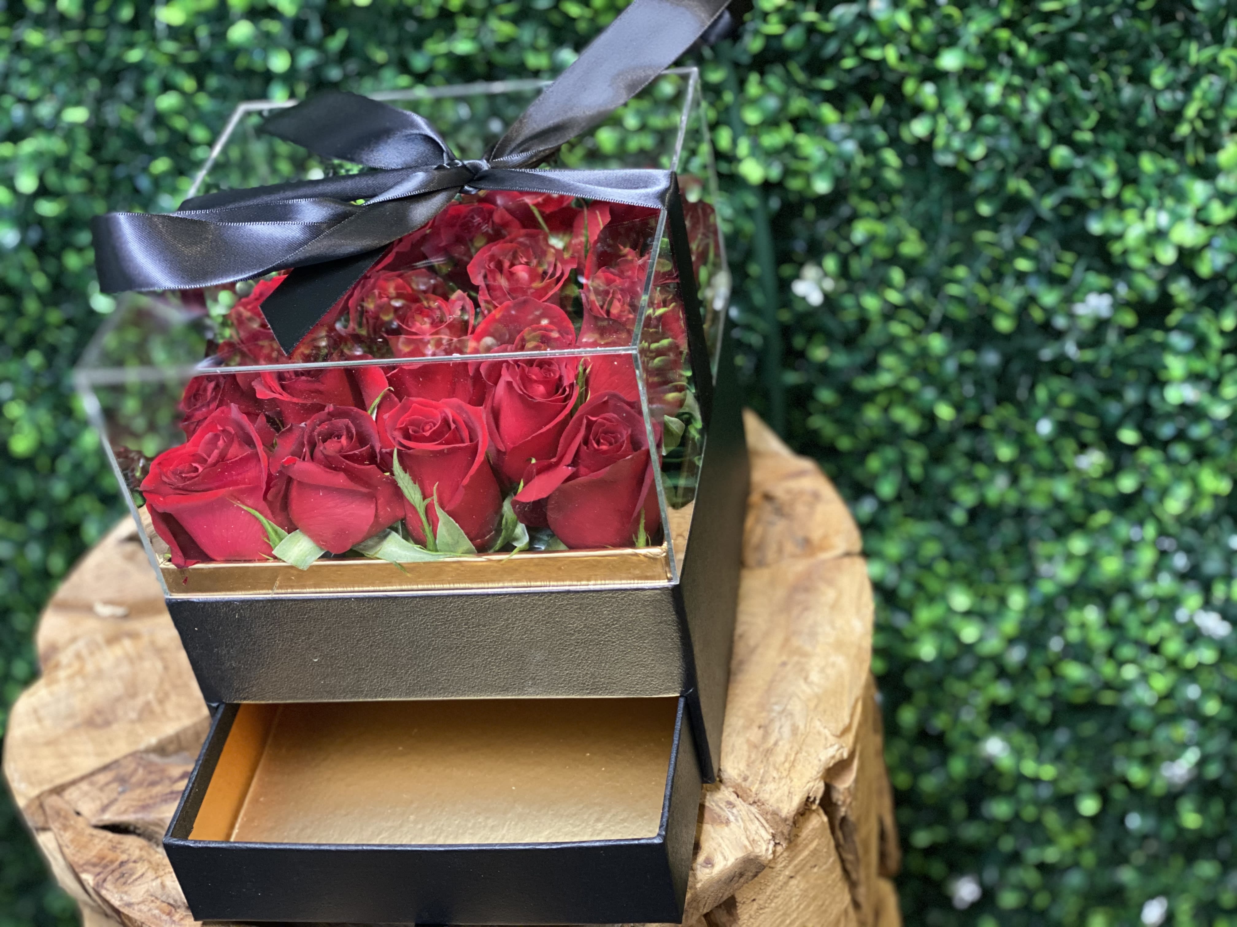 Box of red roses with a black ribbon bow