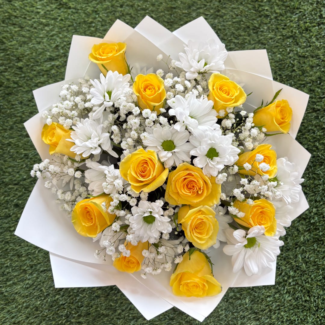 Yellow roses and white daisies in white paper wrap