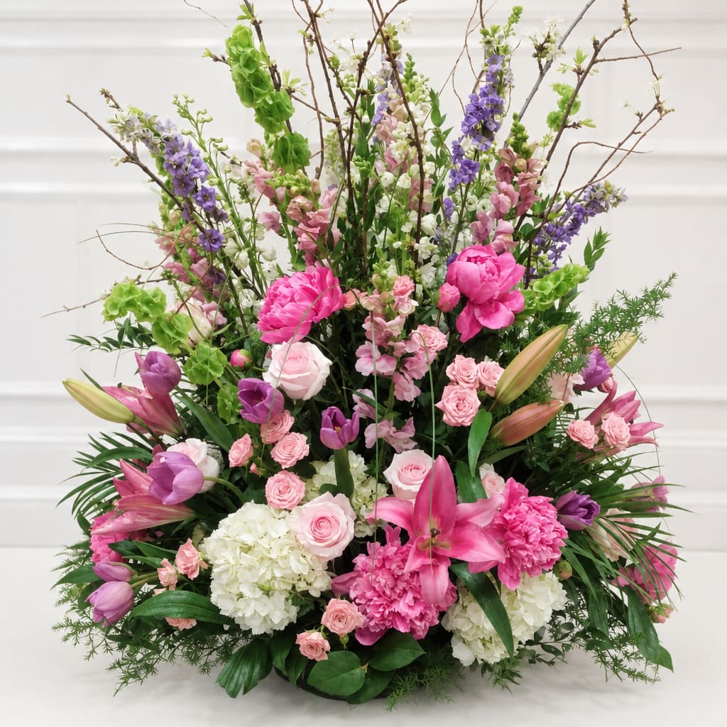 Large mixed floral arrangement with pink, purple, white, and green blooms