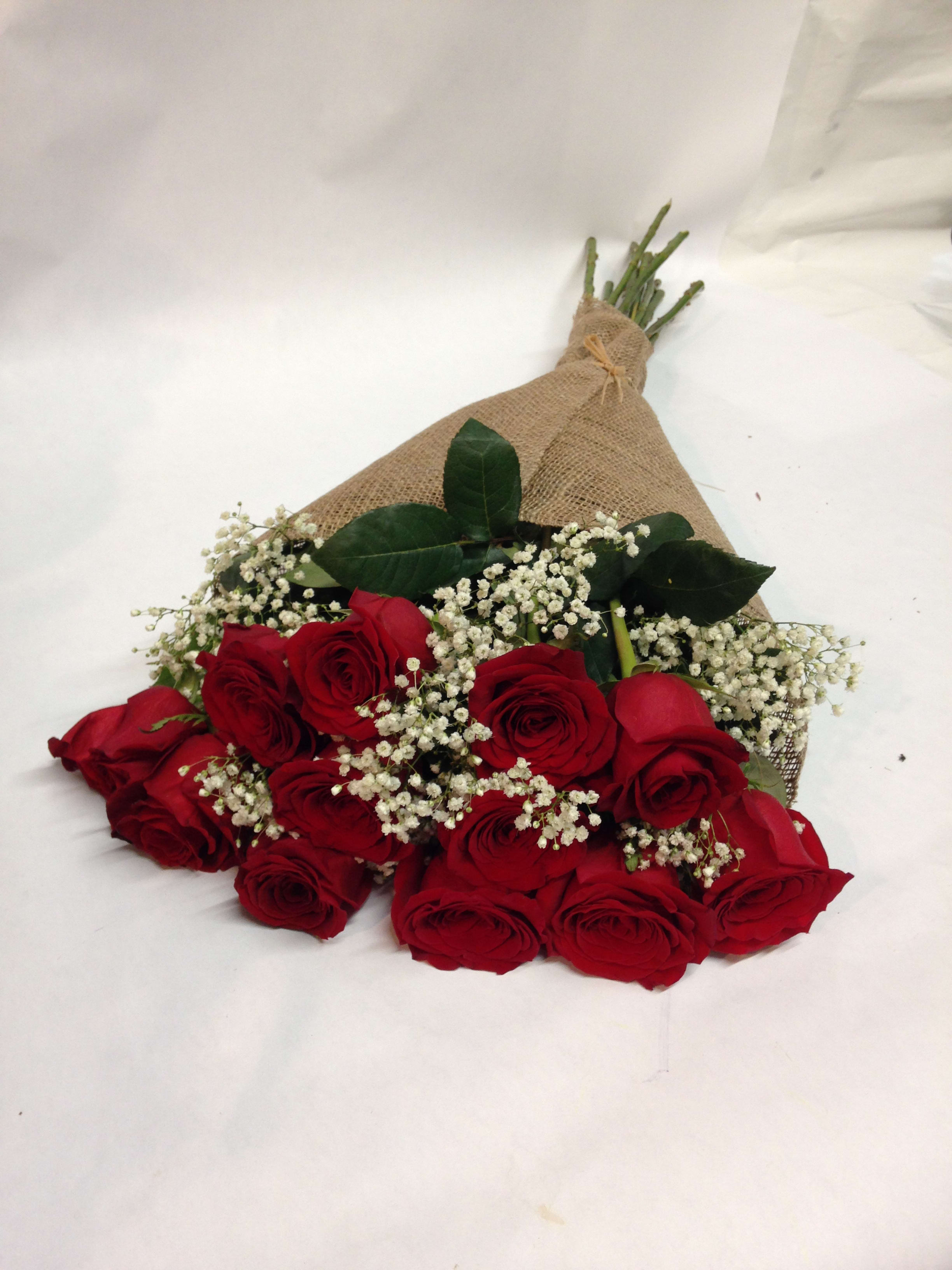 Red  Roses in a Burlap   Wrap - 12 long stem premium red roses come complete with baby's breath and are wrapped in burlap.   We also offer: peach, pink, red, white, orange and hot pink colors.    (Some flowers may be subject to change depending on the season. We will contact you with available flower substitutions; please contact us with specific questions if you are concerned with flower availability, thanks!)  Featured arrangement: One Dozen - 128.00  (Regular Price) Two Dozen - $238.00 (DELAXE PRICE) Three Dozen -$ 328.00 (PREMIUM PRICE)