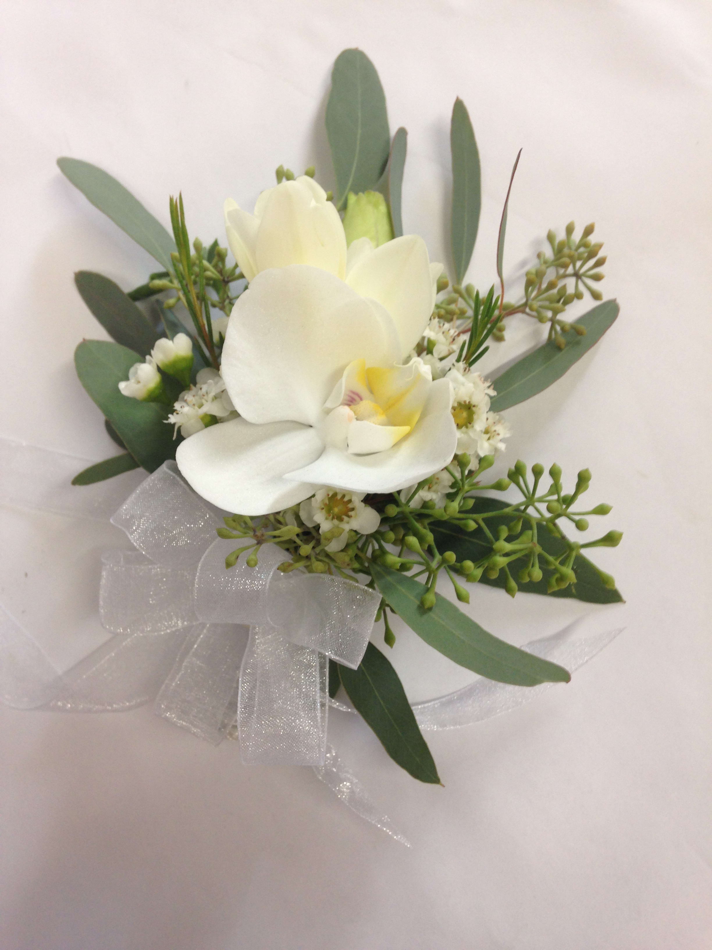White orchid bouquet with greenery and a sheer ribbon