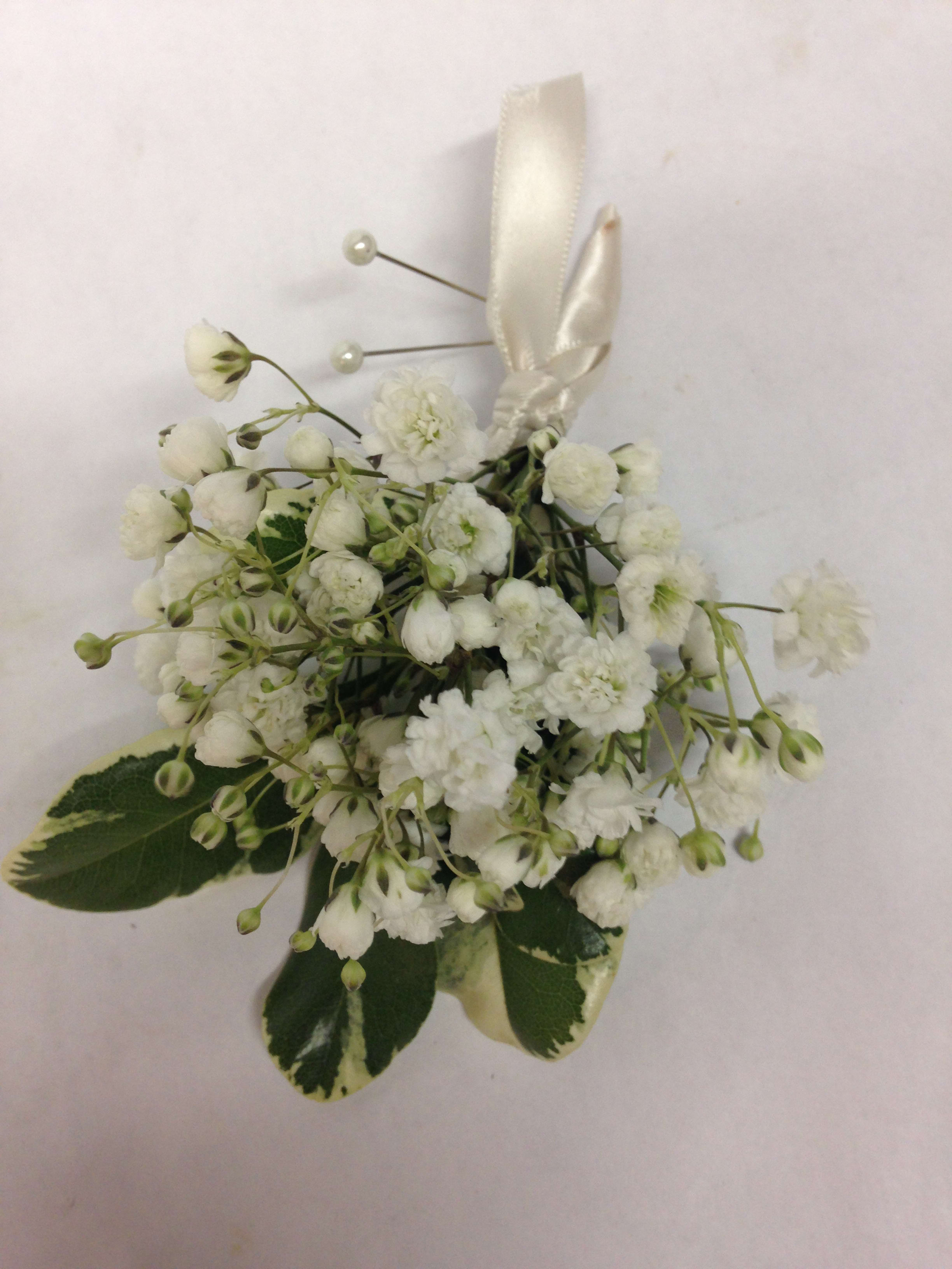 White floral boutonniere with ribbon and pearl pins