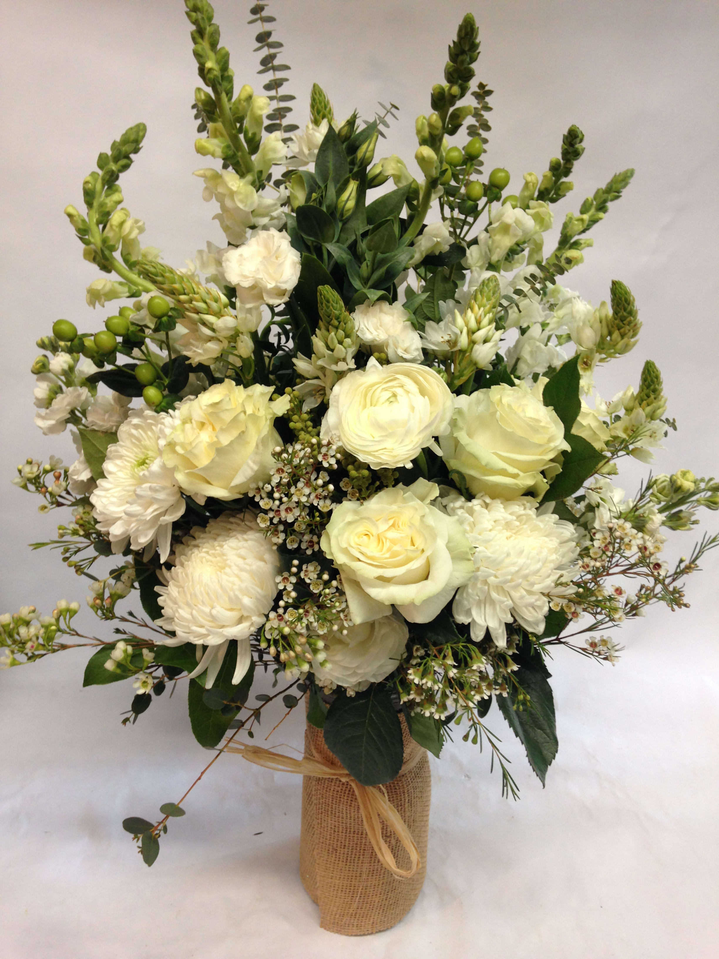 White floral bouquet in a burlap-wrapped vase