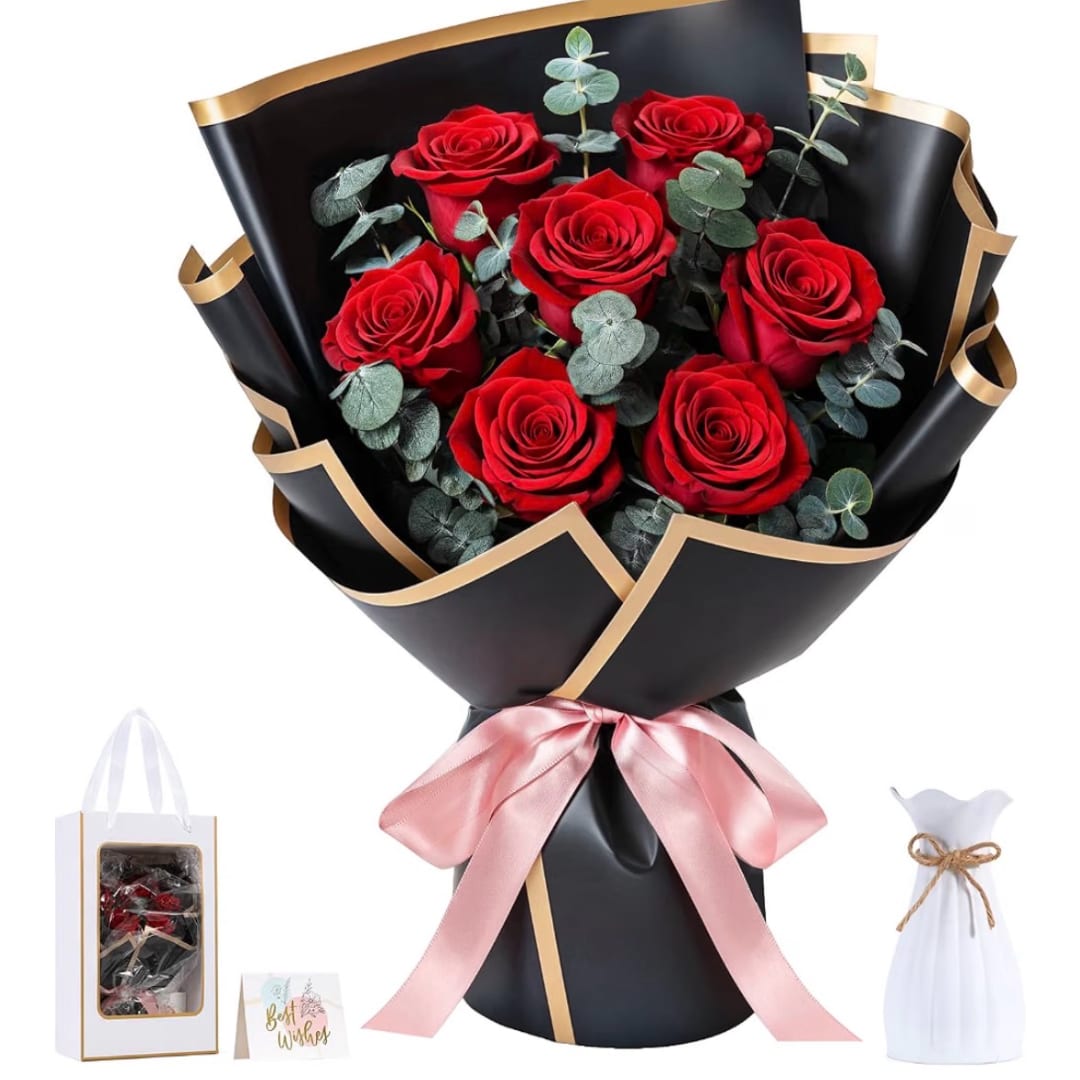 Bouquet of red roses wrapped in black paper with a pink ribbon