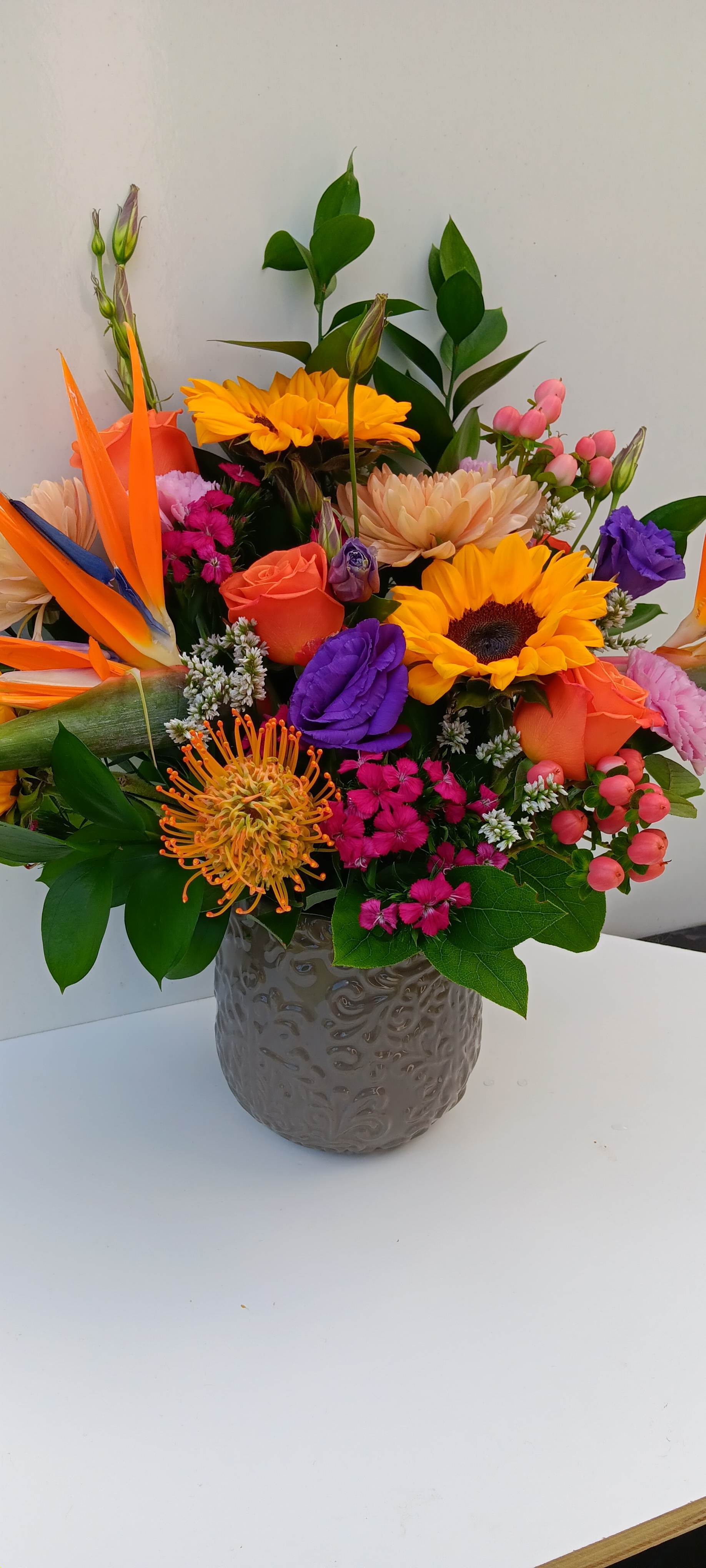 Colorful mixed bouquet in a gray textured vase