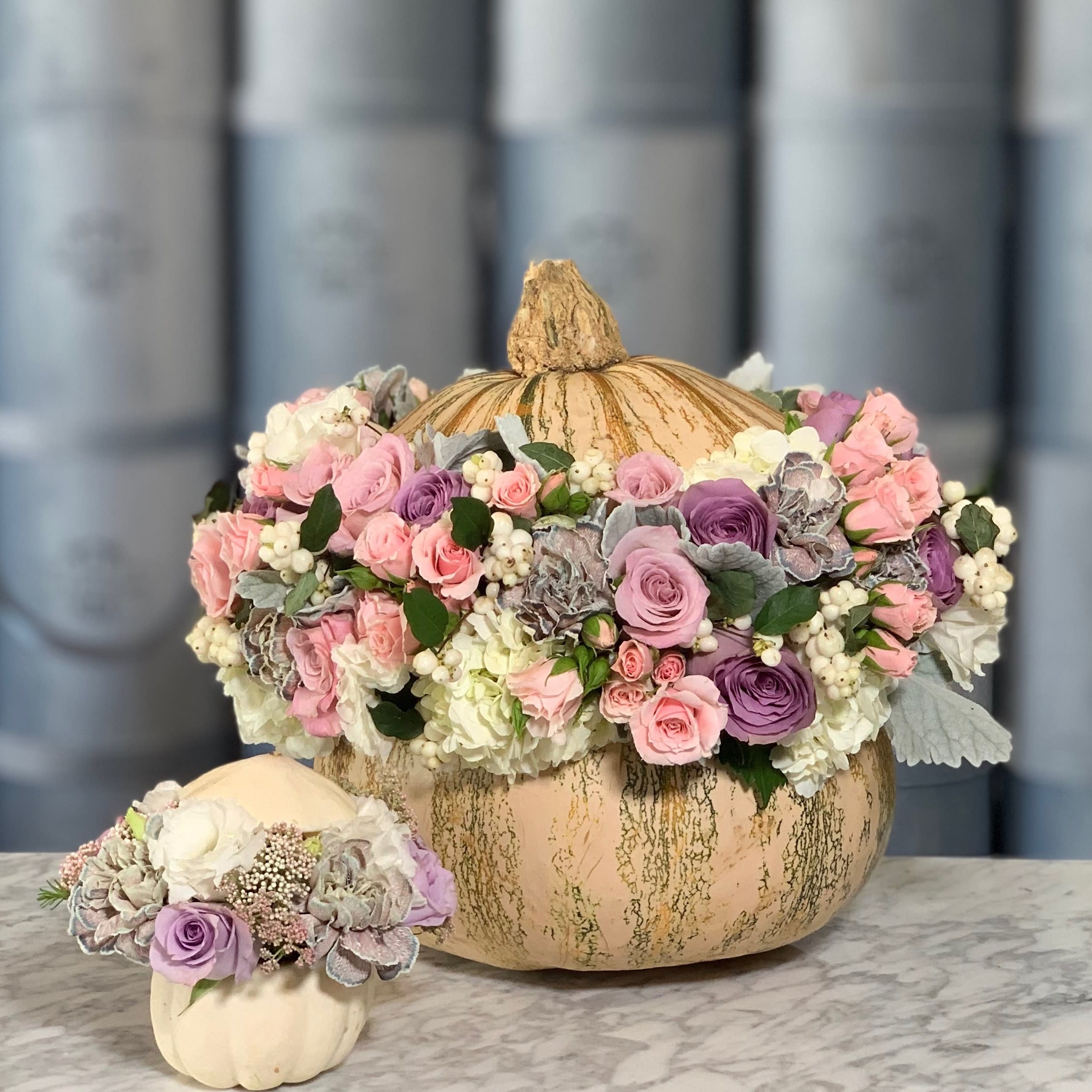 Pumpkin Princess - White pumpkin filled with beautiful mixed arrangement of purple and lavender roses, pink baby roses, carnations, etc. The arrangement includes large pumpkin only. 