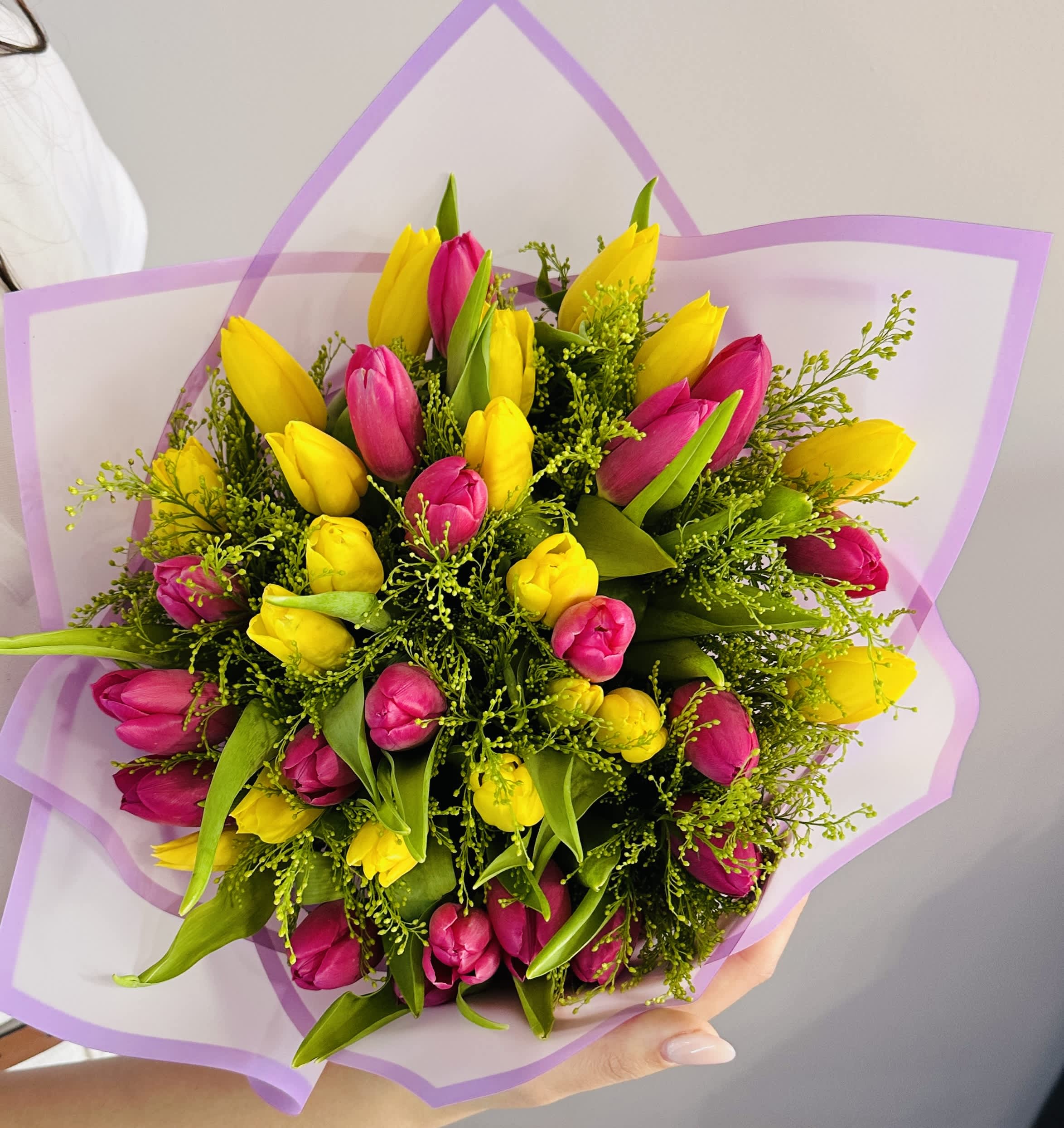 Tulip Bouquet - This stunning tulip bouquet features a vibrant array of tulips in various colors, showcasing their graceful, elongated petals and smooth green stems. Each bloom exudes a sense of freshness and elegance, making this arrangement perfect for celebrating any occasion or simply brightening up your space.  STANDARD size is shown in the main picture. If you would like a specific color of tulips please mention that in the notes
