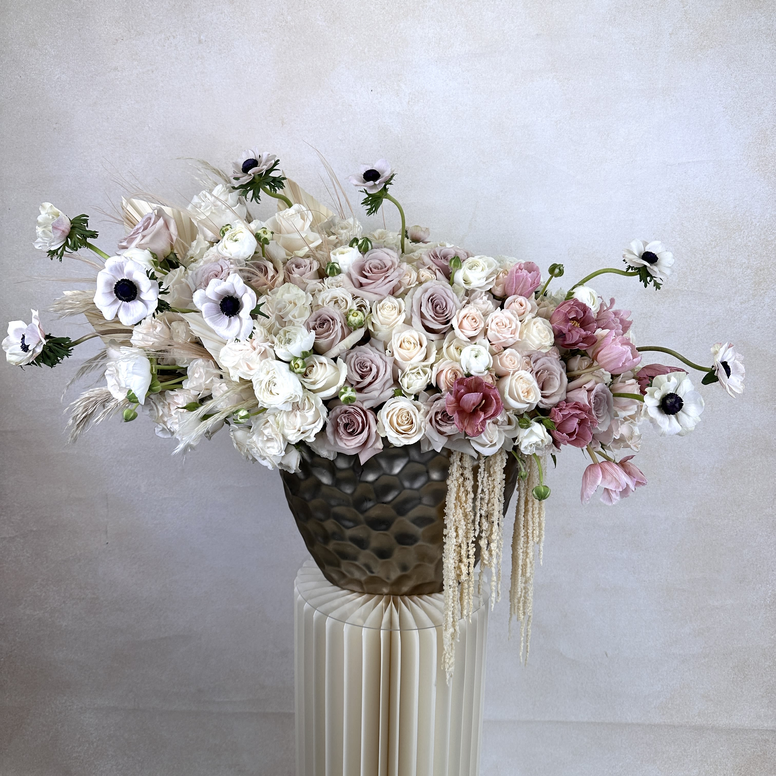 Helen P - A stylish fusion of fresh, high-end flowers designed in a statement vase. An extravagant blend of lush roses and seasonal blooms in a luxurious vase.  Elevate any space with this lavish arrangement, perfect for making a grand impression.  PREMIUM is in the photo.