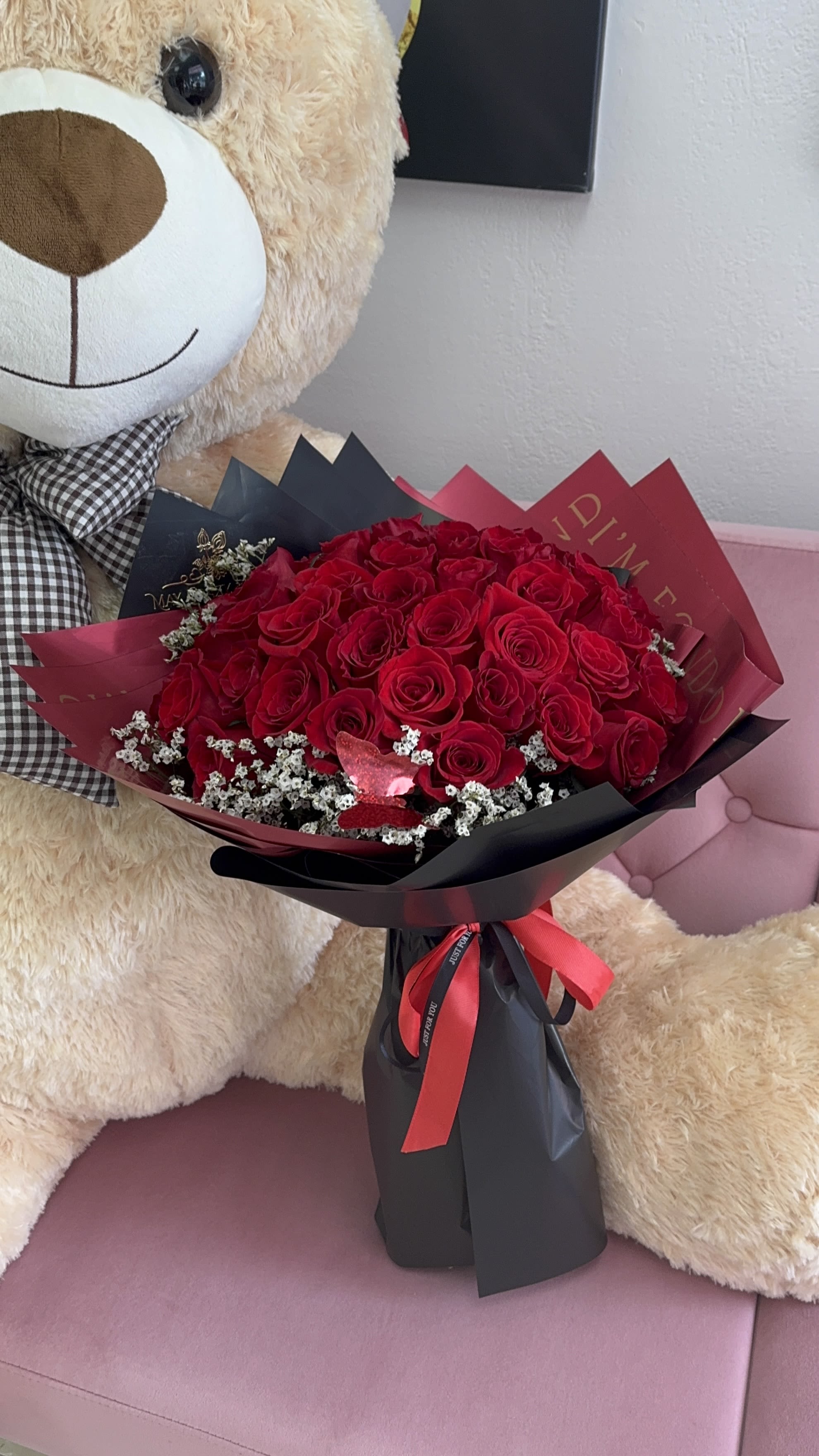 Bouquet of red roses wrapped in black and burgundy paper