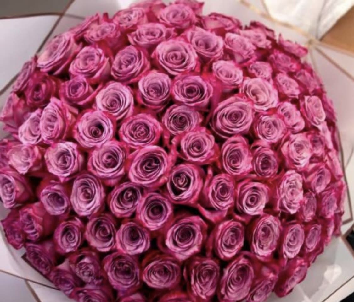 Large bouquet of pink roses wrapped in paper