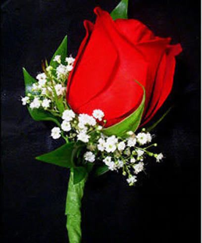 Corsage and Botonier  - A single red rosebud corsage and matching boutonniere crafted for romantic occasions like anniversaries, weddings, or prom. The look is classic: vivid red roses set against clusters of small white filler blooms and glossy green leaves so the recipient will feel noticed and celebrated the moment they see it.  The wrist corsage features two red roses secured on a silver bracelet band and tied with a sleek black ribbon for a dressed-up, wearable finish; the boutonniere echoes the same palette with a single large red rosebud and white accents for a compact, elegant pairing. The compact, formal design keeps the bloom as the focal point while the contrast of red, white, green, and black reads traditional and timeless.  Perfect for a partner, prom date, or someone standing at the altar, this set sends a clear message of love and celebration without fuss. Sizes are kept intentionally petite and wearable; to keep blooms fresh, store refrigerated until use and avoid direct heat or drafts before the event.
