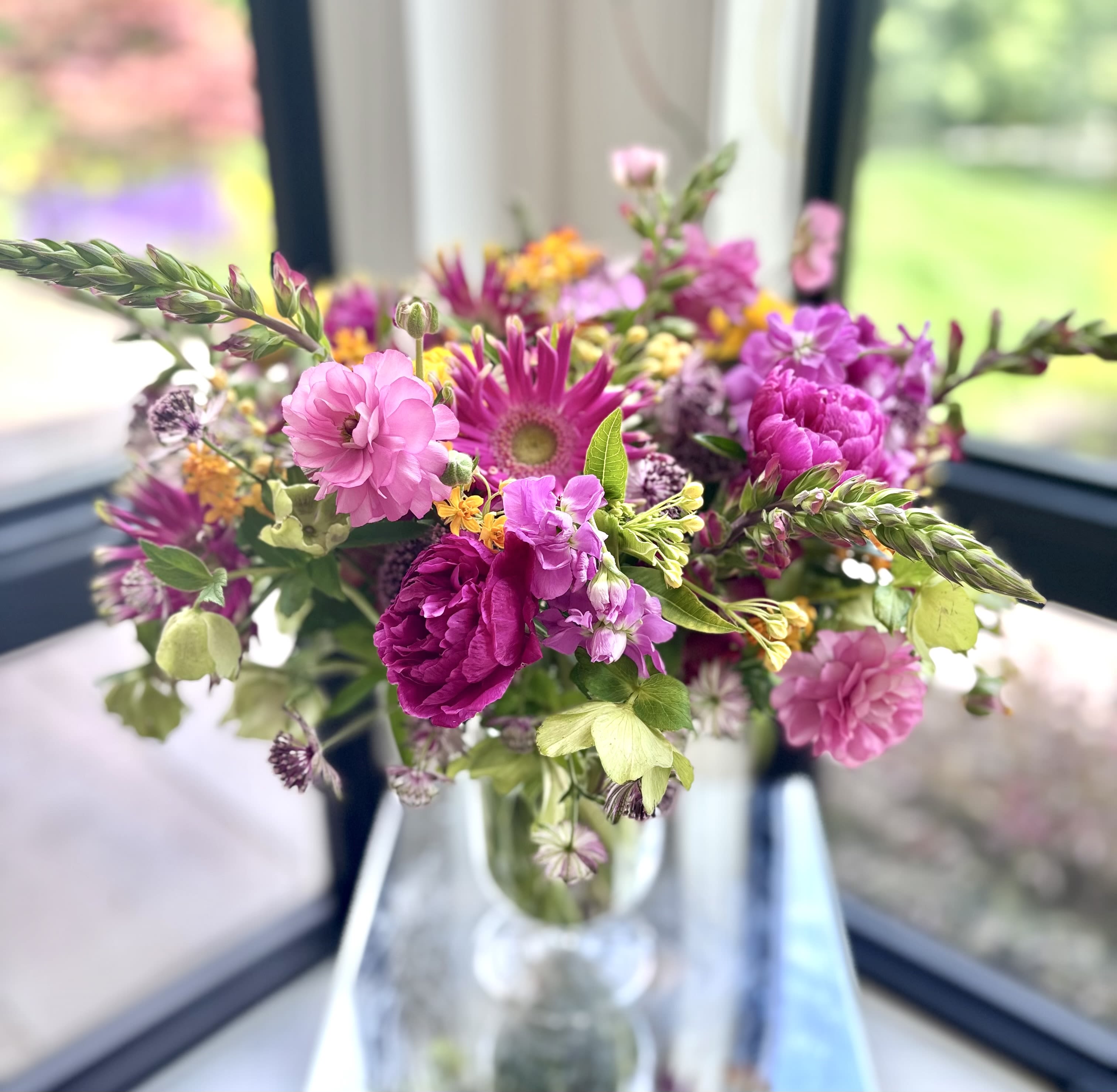 Seasonal Beauty By Yours Truly - A vase filled with fresh seasonal, some locally grown flowers arranged by Michaela in a garden/wild flower meadow style. The colors and selection of flowers may vary based on the availability. We always select premium fresh flowers.