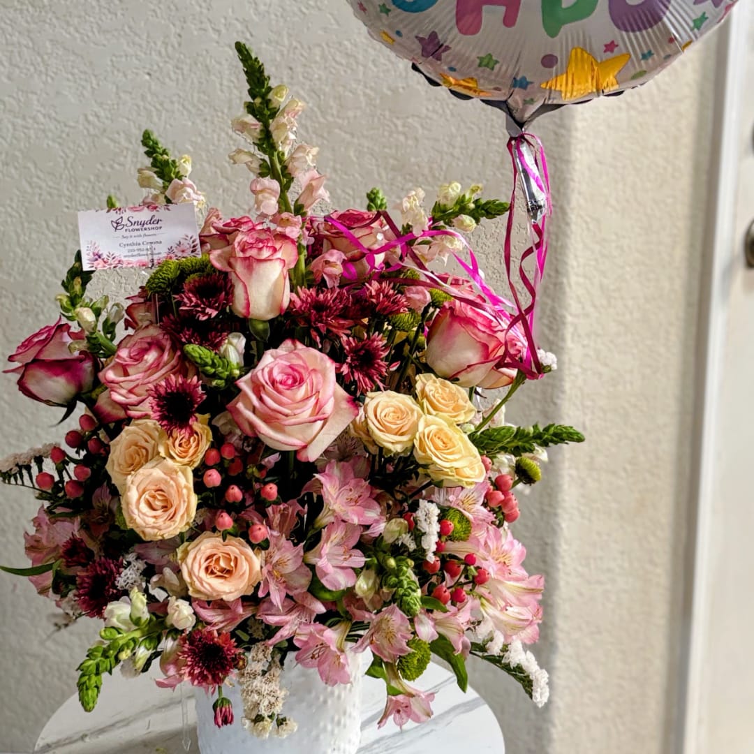 Pink and cream rose bouquet in a white vase with a birthday balloon