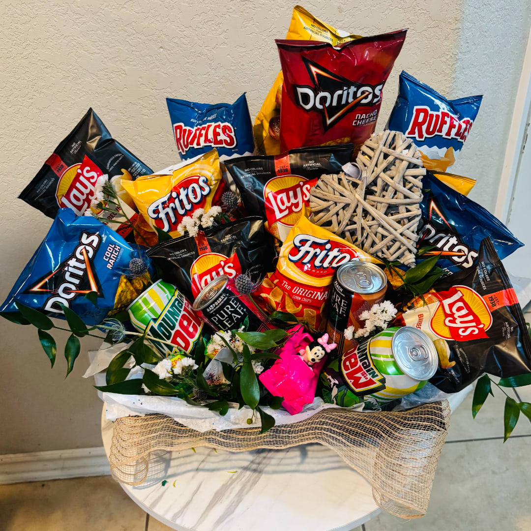 Snack bouquet with chips, soda cans, and faux flowers in a burlap-wrapped basket