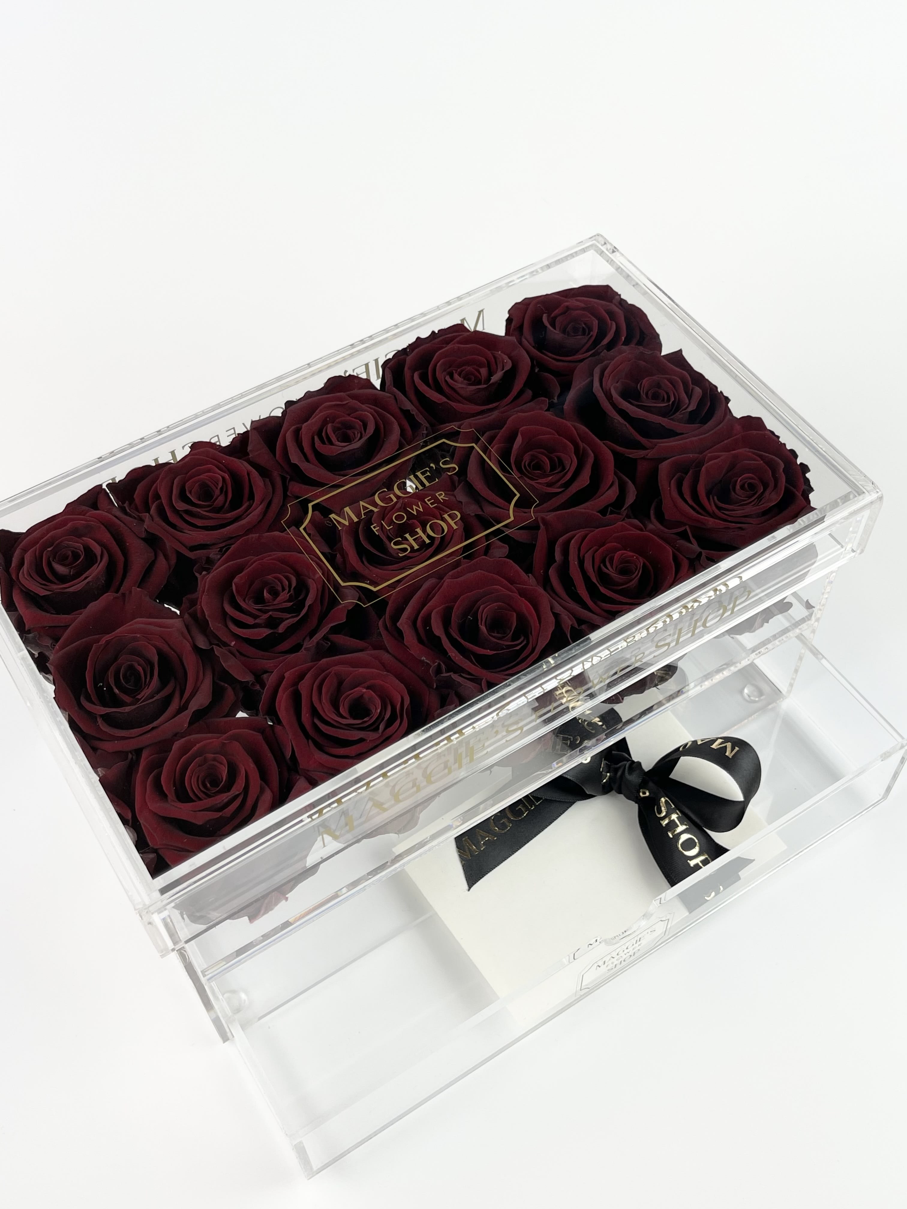 Box of deep red roses in a clear acrylic case