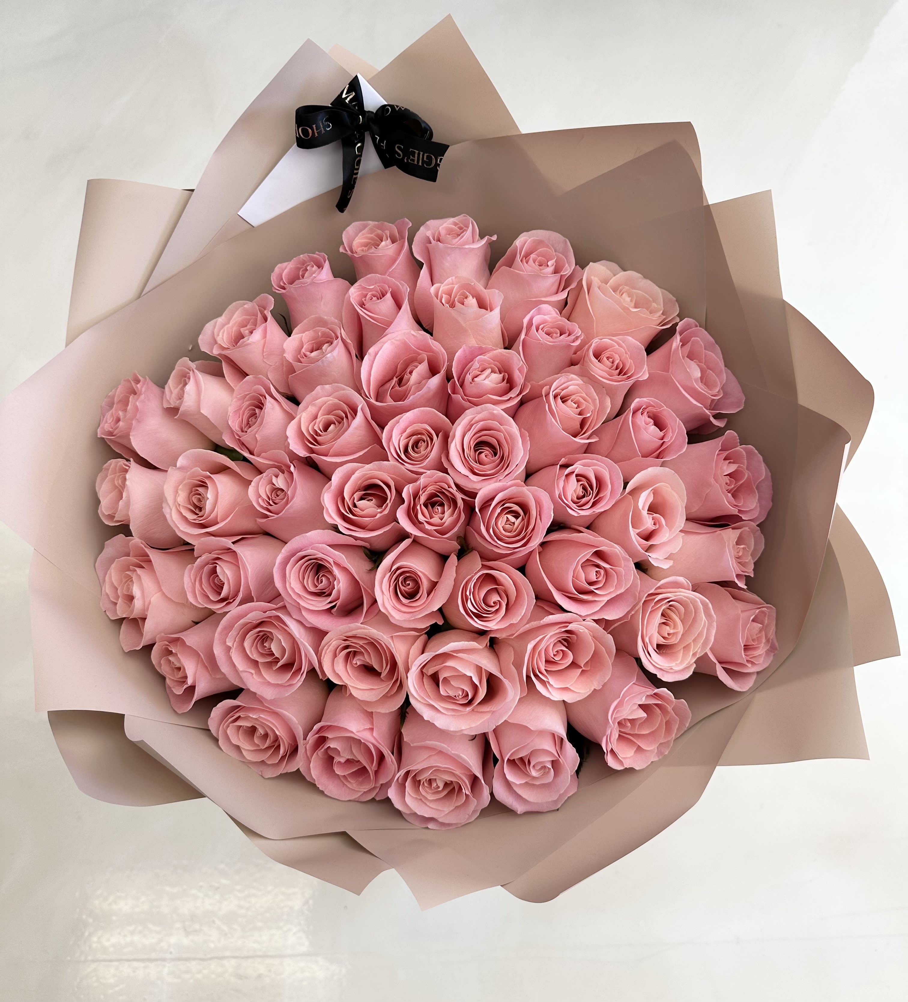 Bouquet of pink roses wrapped in blush paper