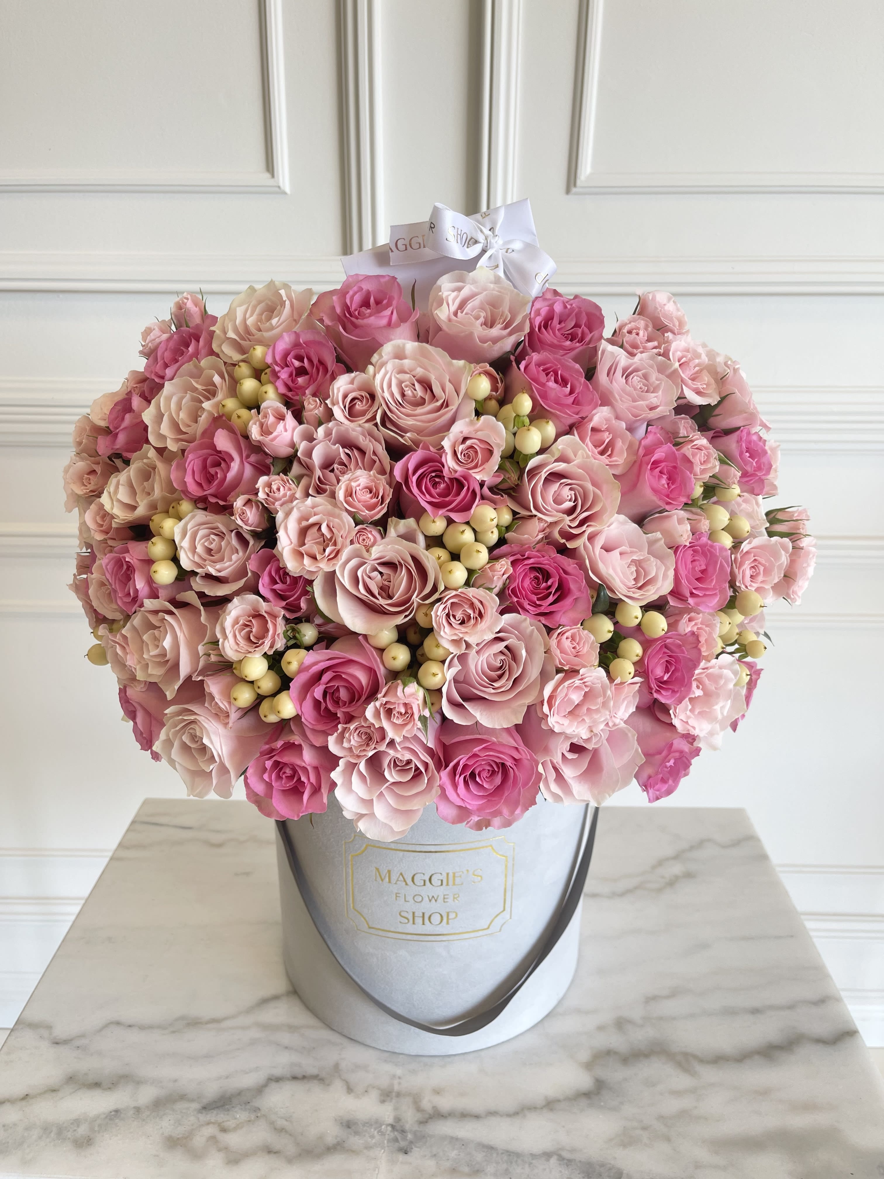 Large pink rose bouquet in a round hat box