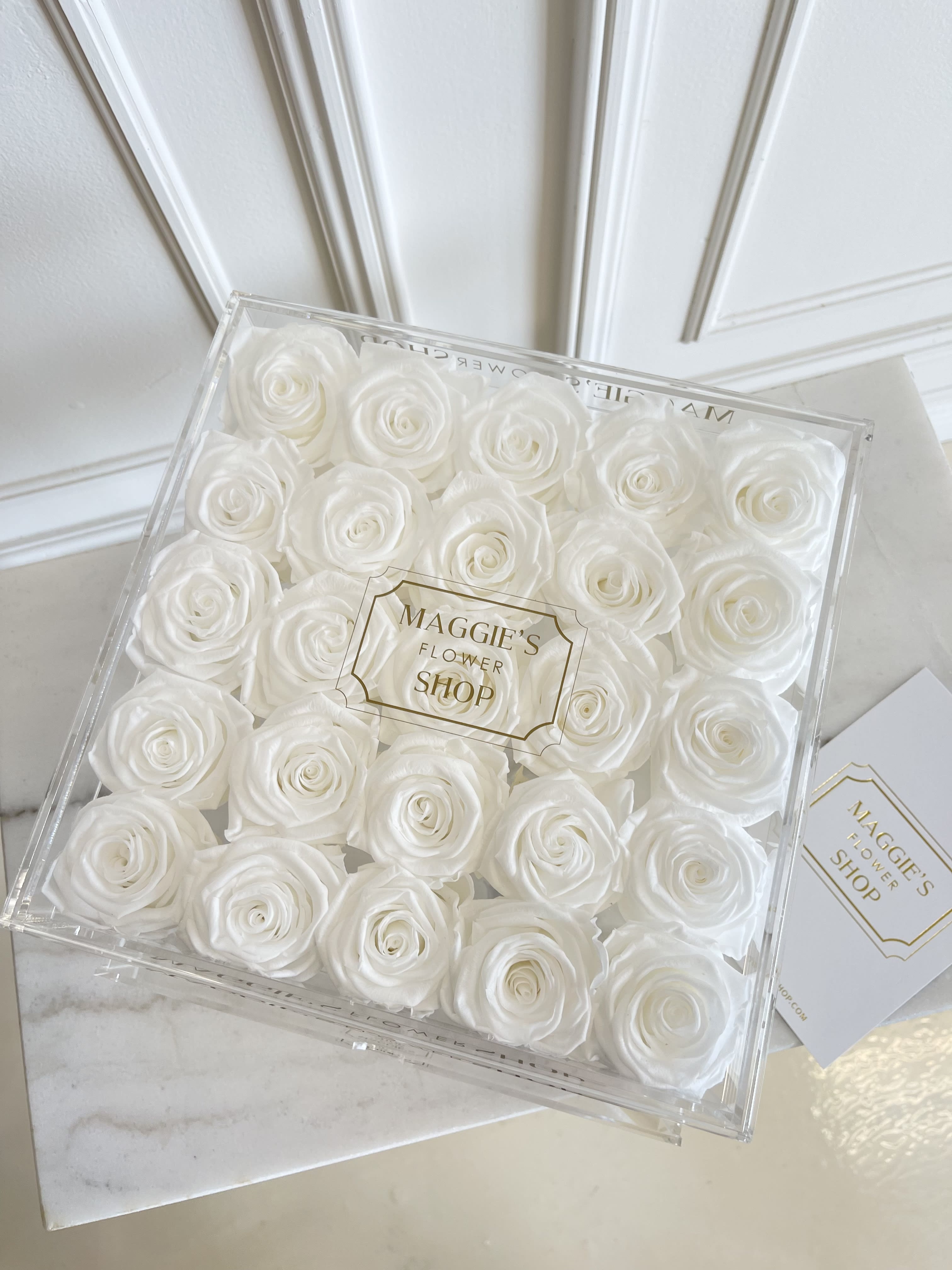 Box of white roses in a clear square gift box