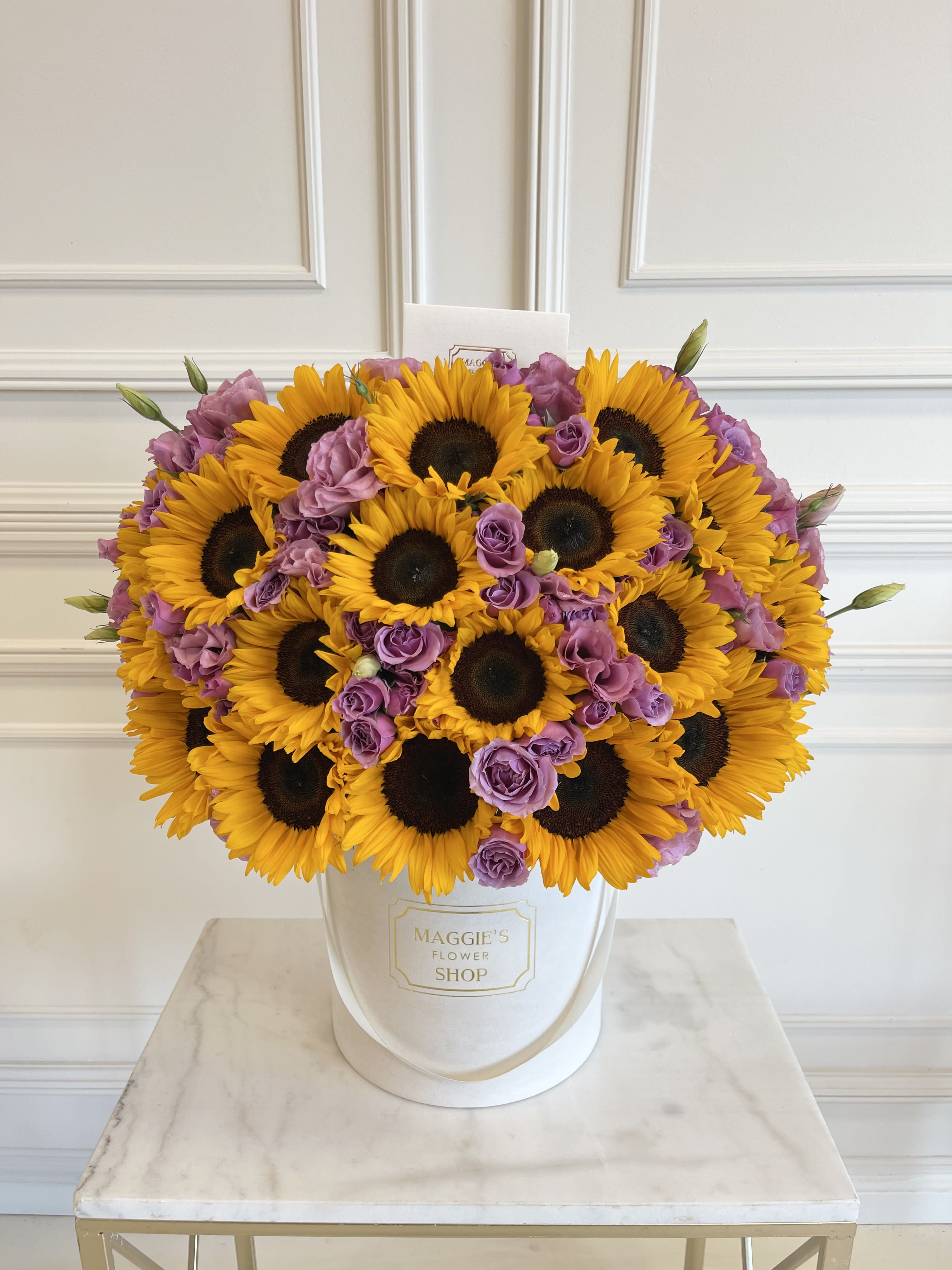 Sunflower and lavender rose bouquet in a white hat box