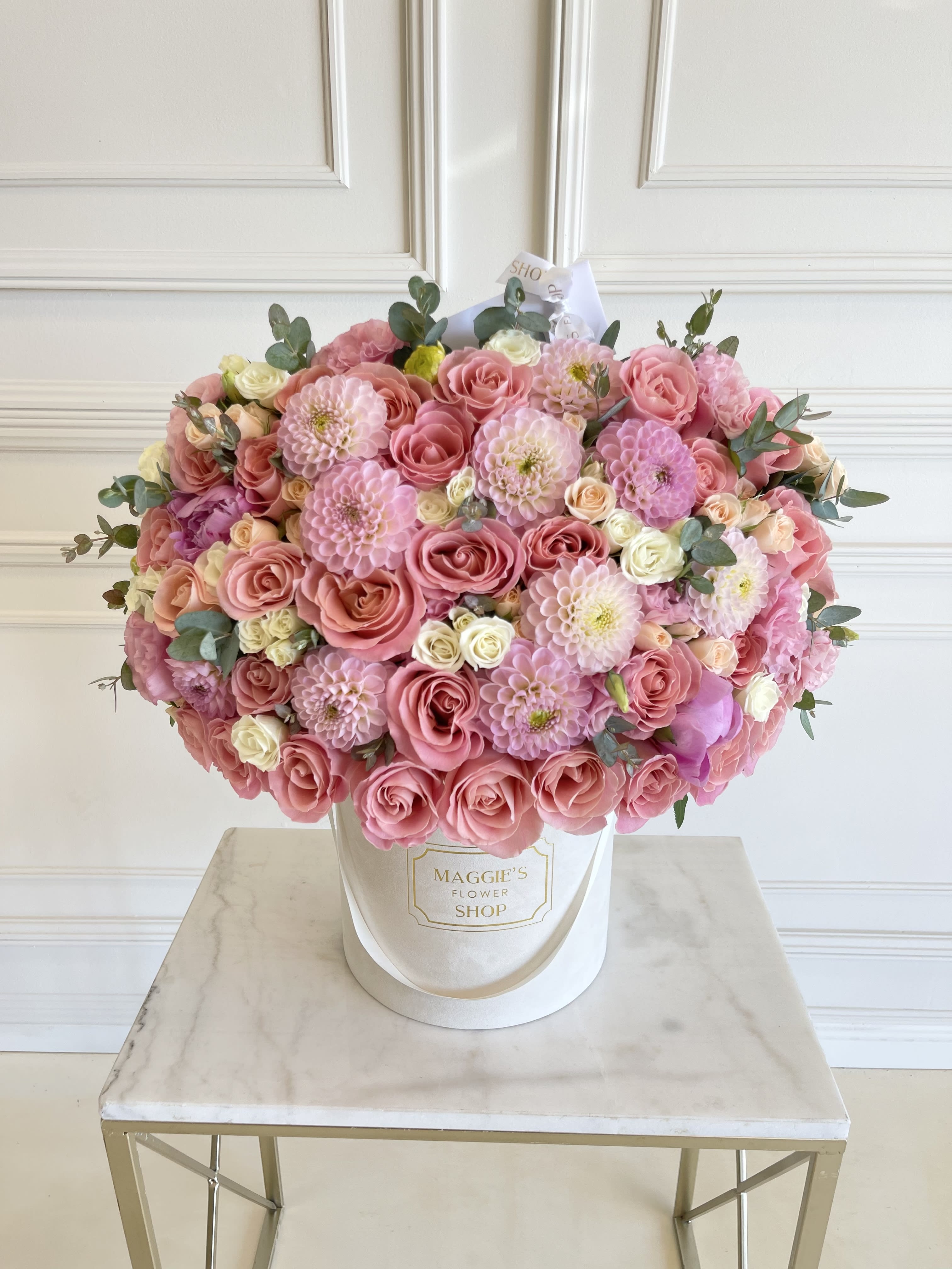 Large pink rose and dahlia arrangement in a white hatbox
