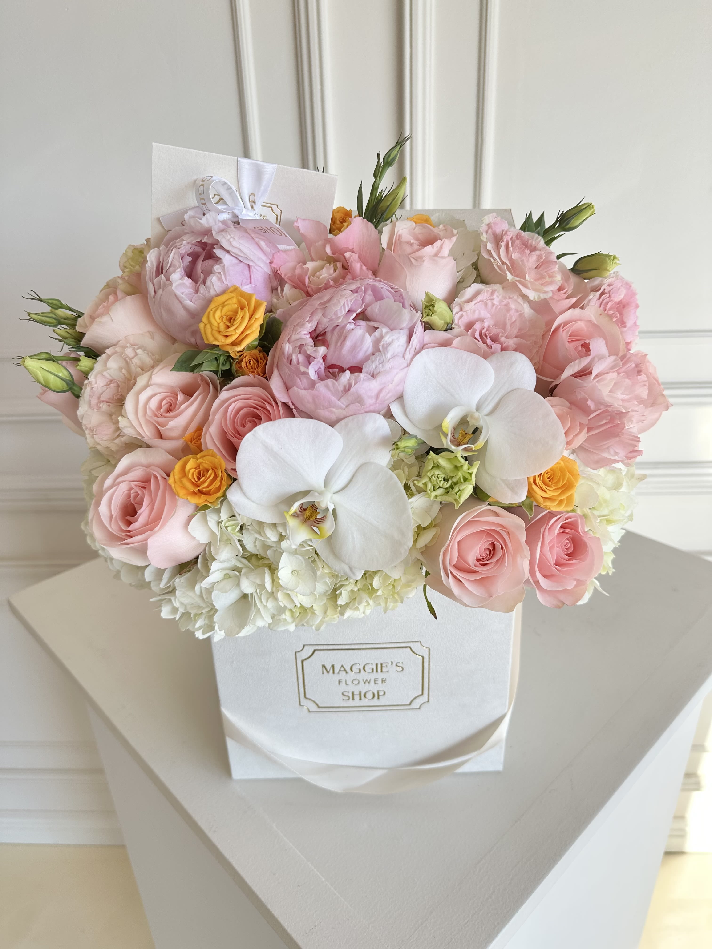 Pink and white flower bouquet in a white gift box