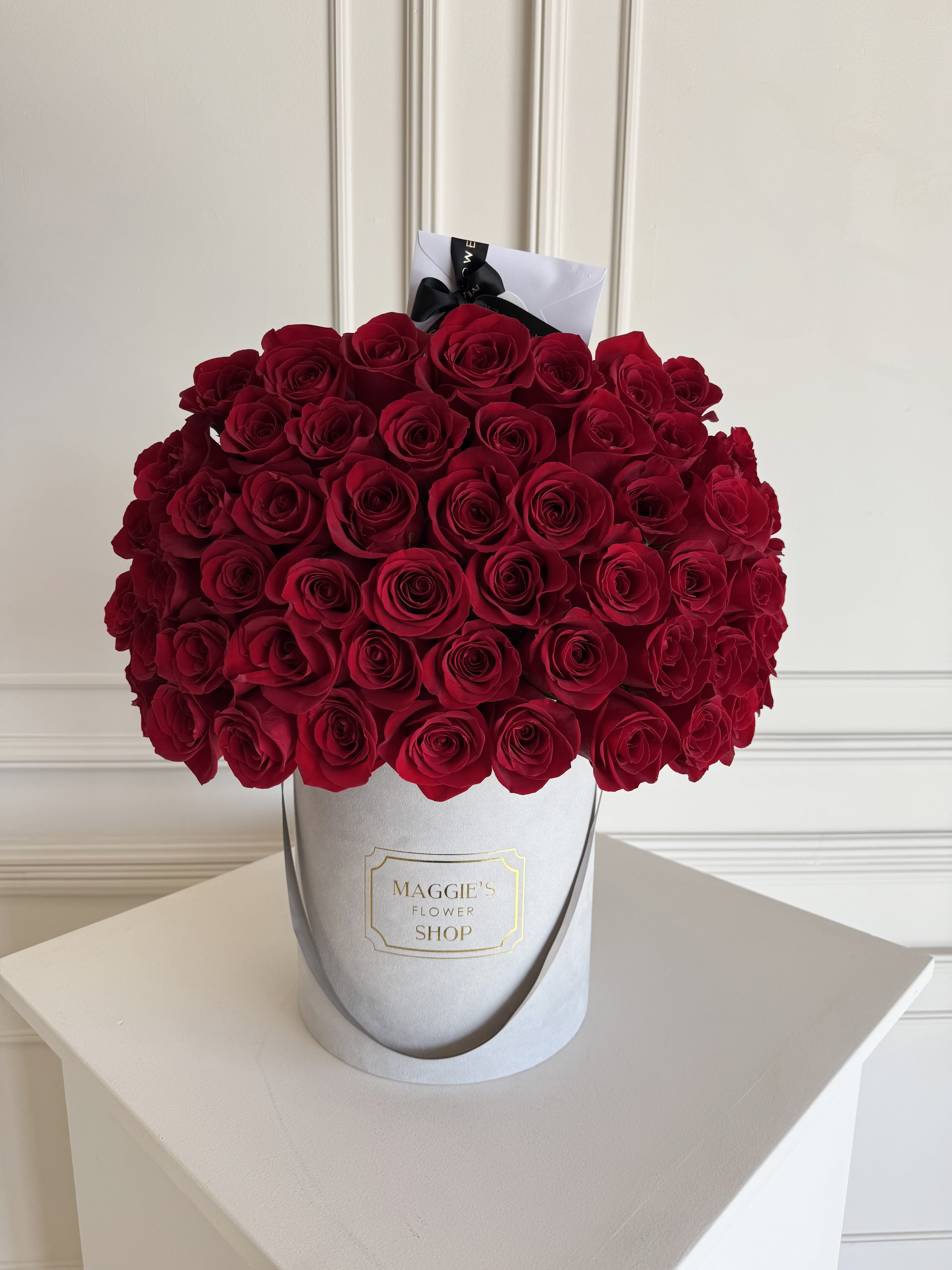 Large bouquet of red roses in a white hat box