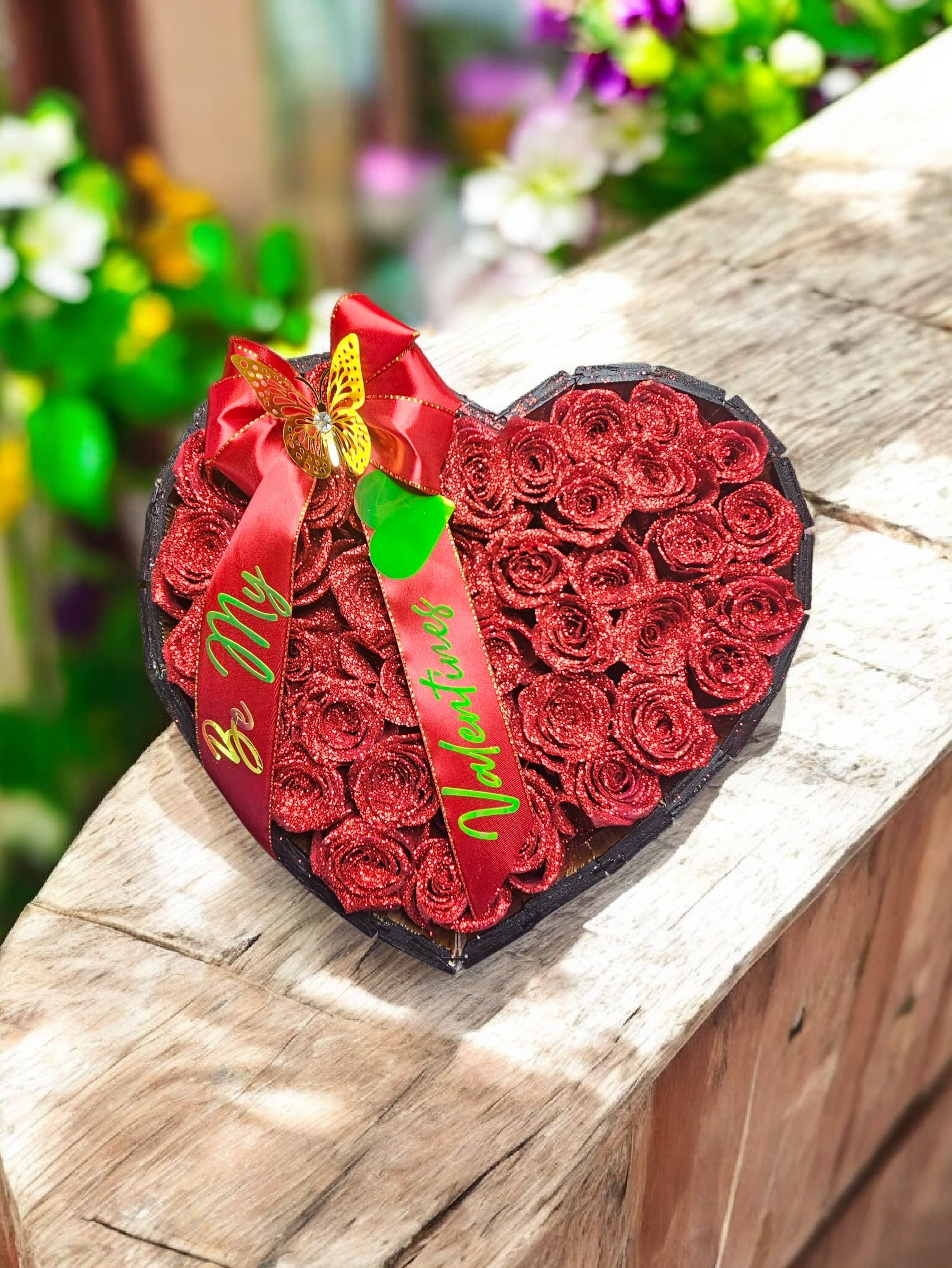 Heart Box Roses - A plush heart-shaped box overflowing with glittery red silk roses makes a show-stopping romantic gift for anniversaries, Valentine's Day, or any moment you want her to feel adored. The densely packed red roses create a rich, textured surface that reads both luxurious and playful-the kind of arrangement that instantly communicates love and celebration to the person you're thinking of.   This is the kind of gift that makes someone feel truly seen-romantic, thoughtful, and delightfully tactile. Order now for a hassle-free, long-lasting expression of affection; no vase or care required, just unbox and enjoy.