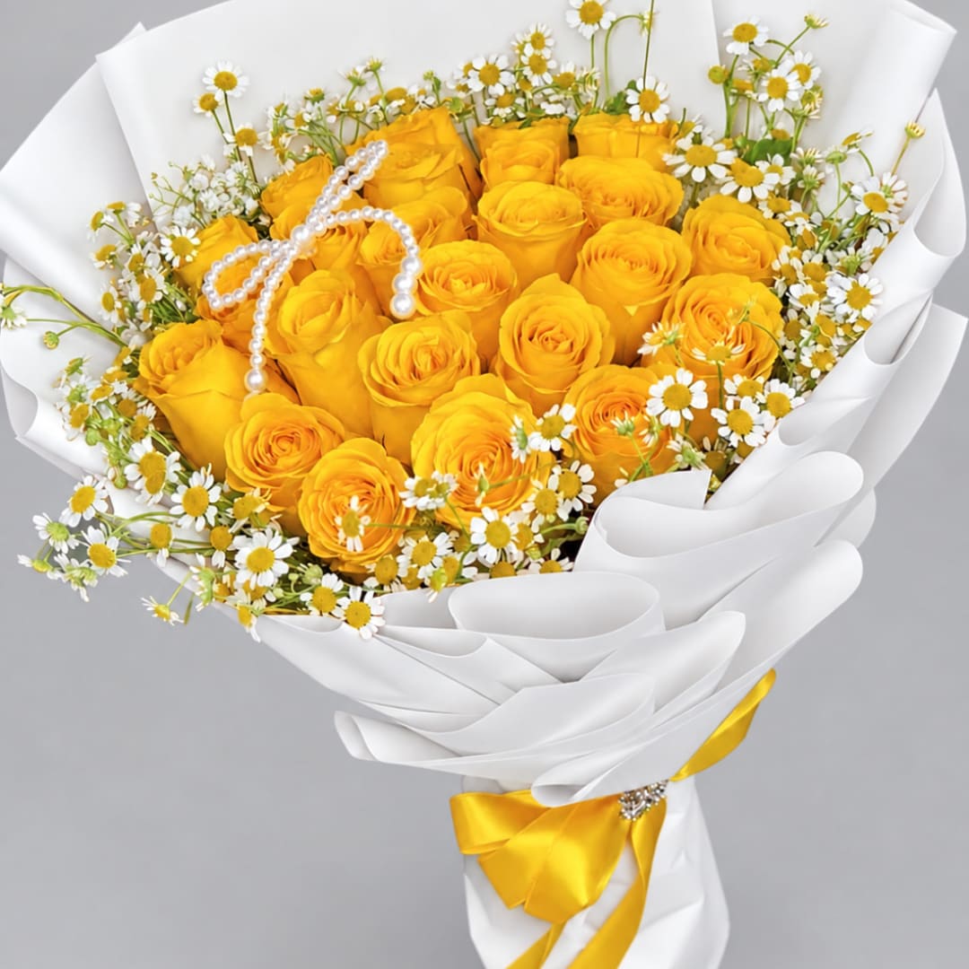Bouquet of yellow roses and small white daisies wrapped in white paper