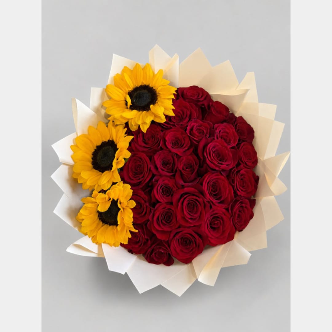 Bouquet of red roses with three yellow sunflowers in white wrap