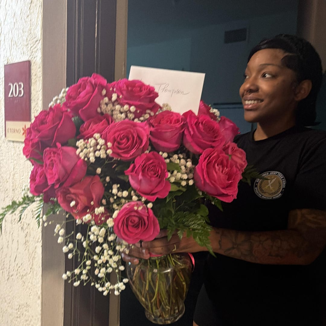 Large bouquet of hot pink roses in a glass vase