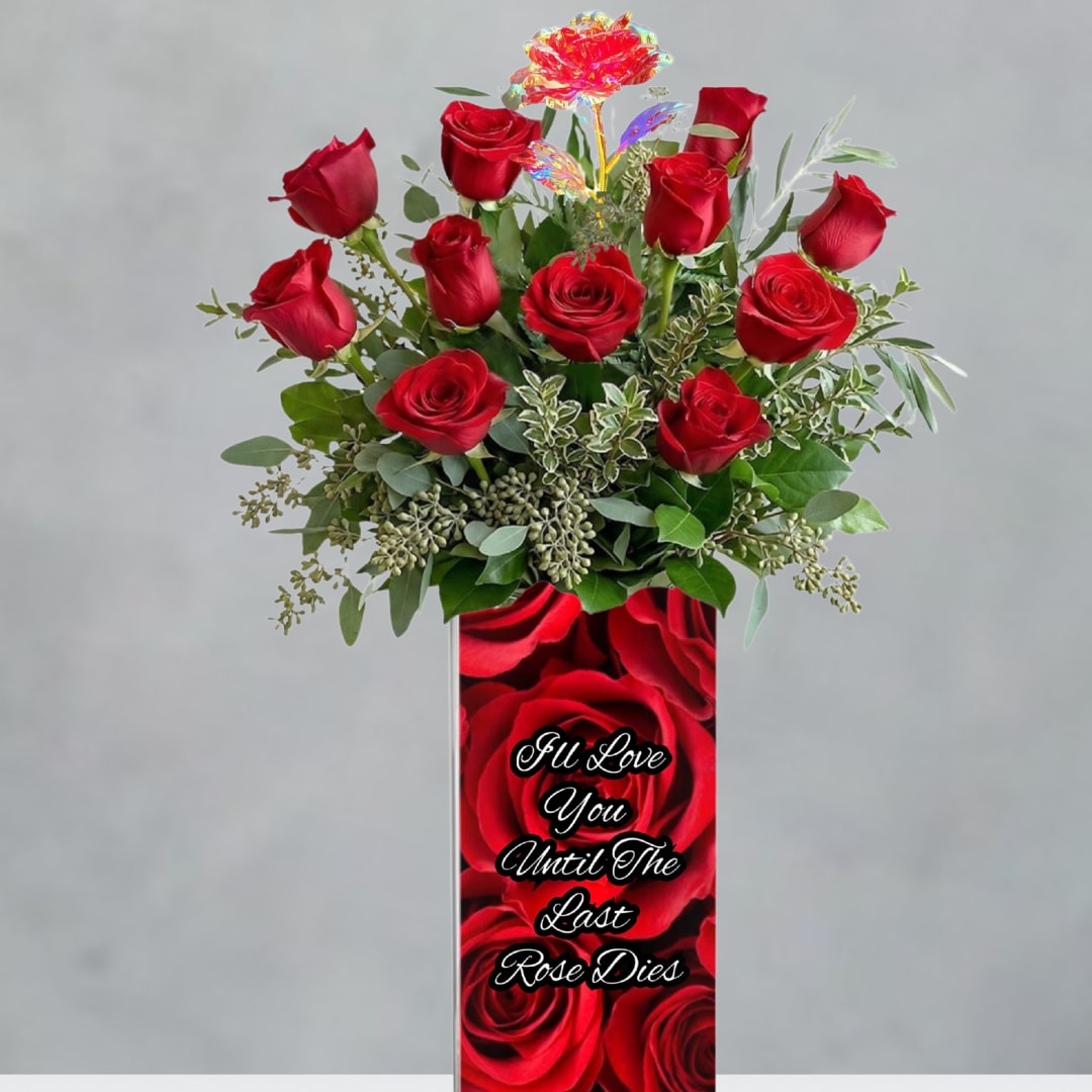 Red roses in a tall vase with a printed love message
