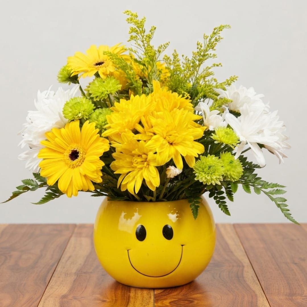 Yellow and white flower arrangement in a smiley-face vase