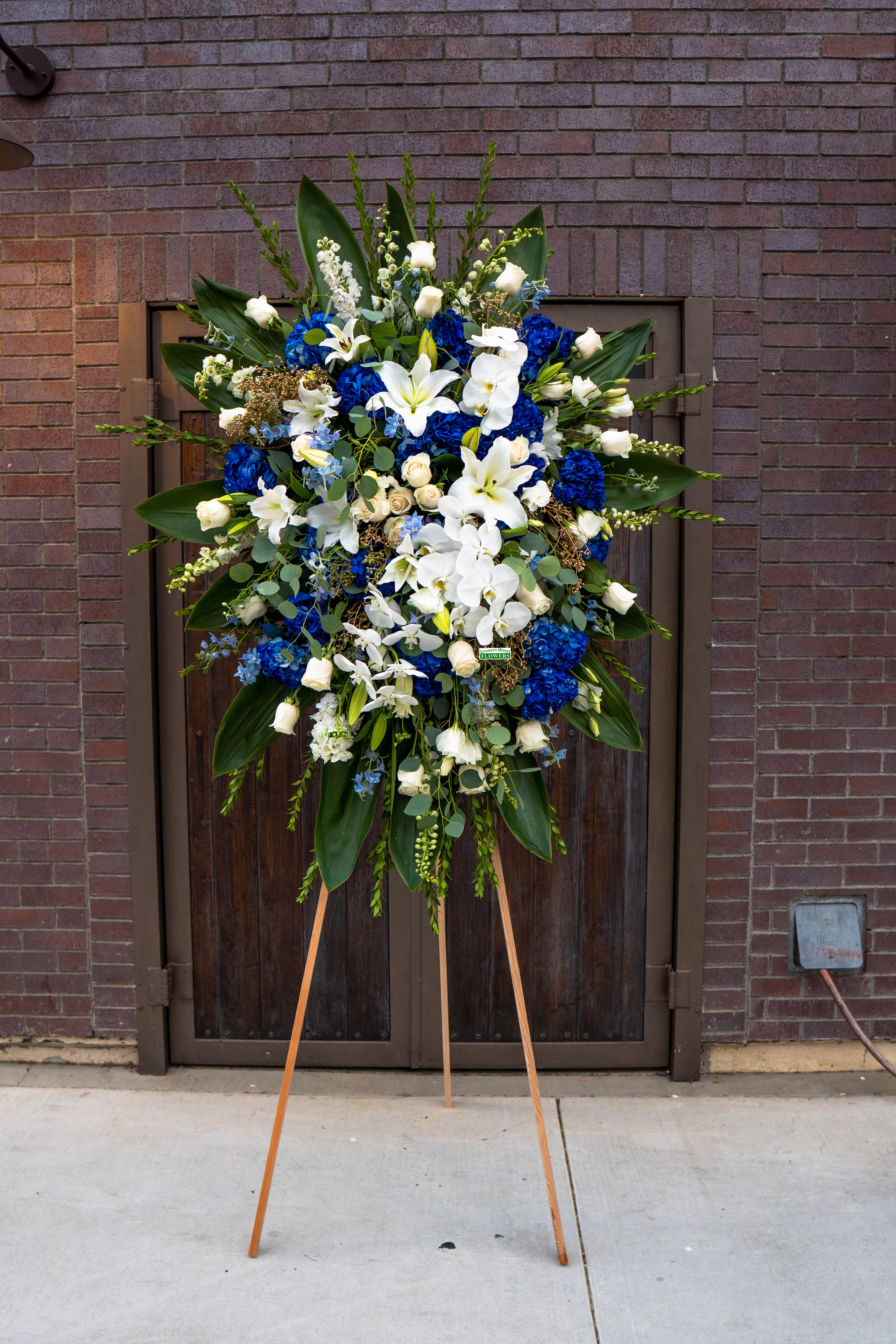 Blue &amp; White Luxury  - A beautiful mixture of blue and white flowers. The standing spray includes the isle.