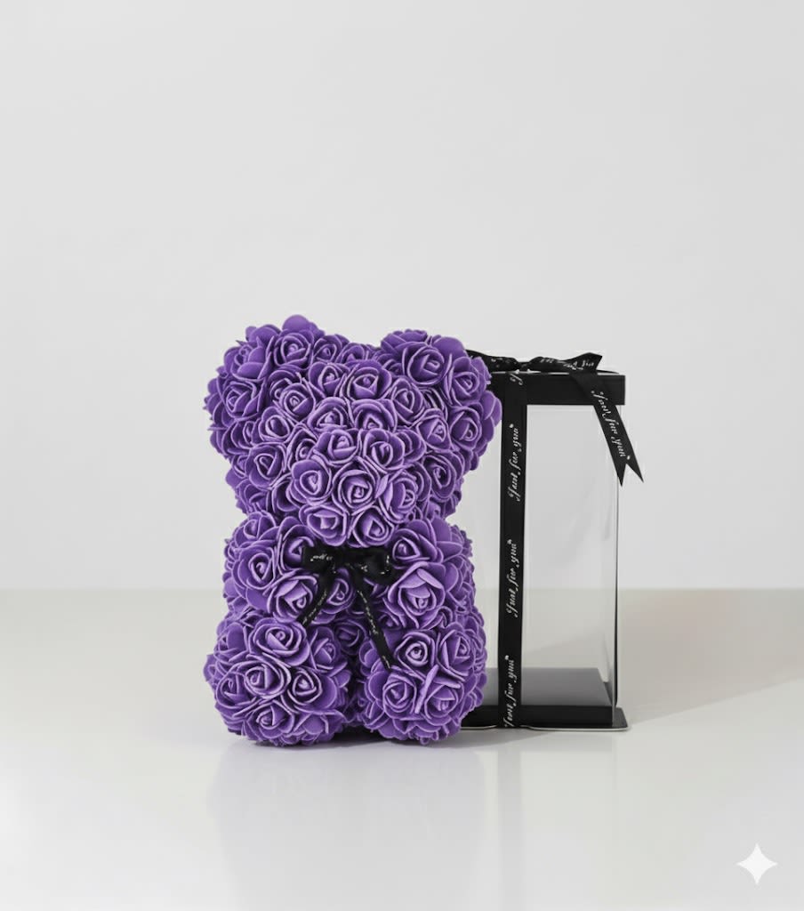 Purple rose teddy bear with a black ribbon on a clear stand